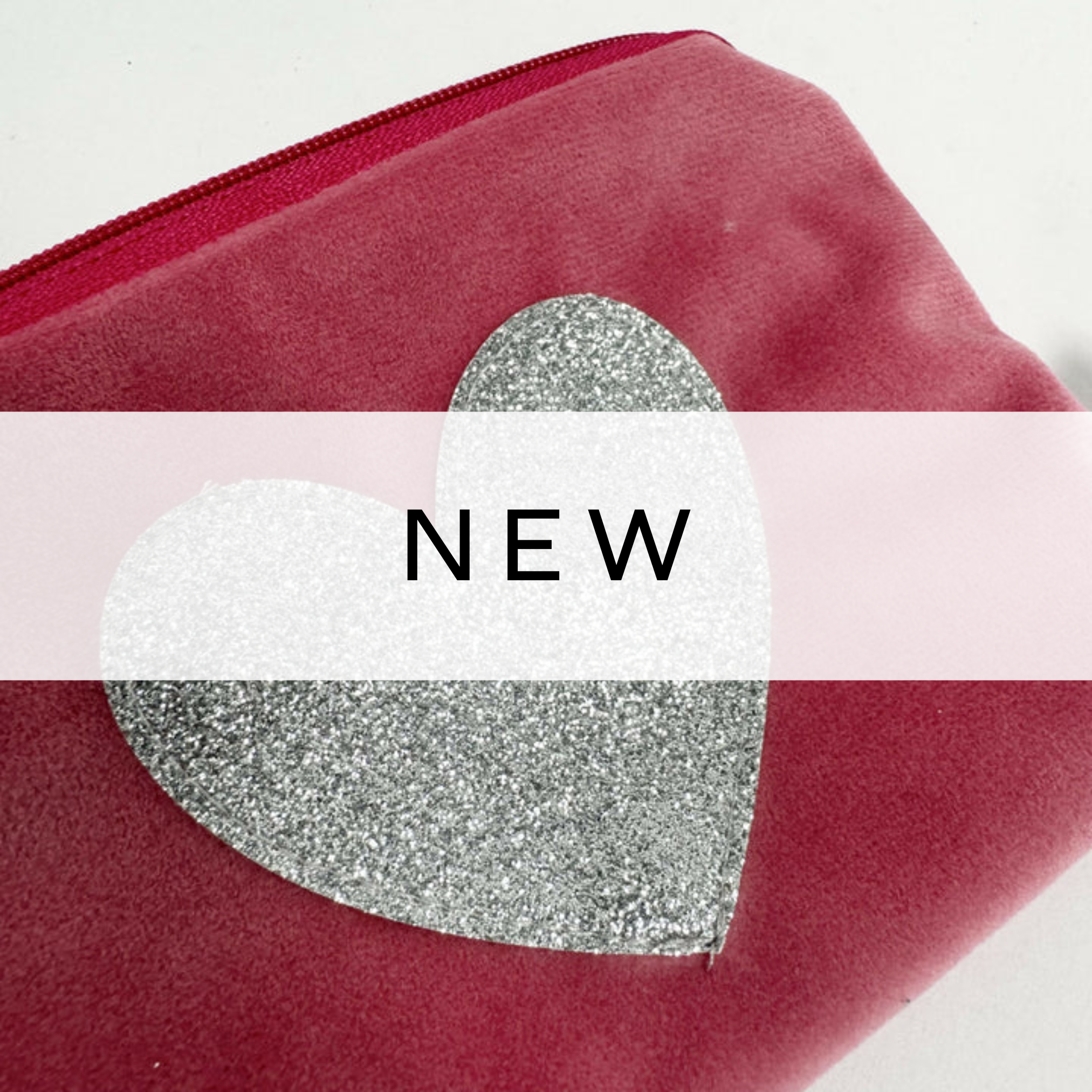 A vibrant red pouch featuring a sparkling silver heart design, perfect for storing small essentials with a touch of glamour and charm.