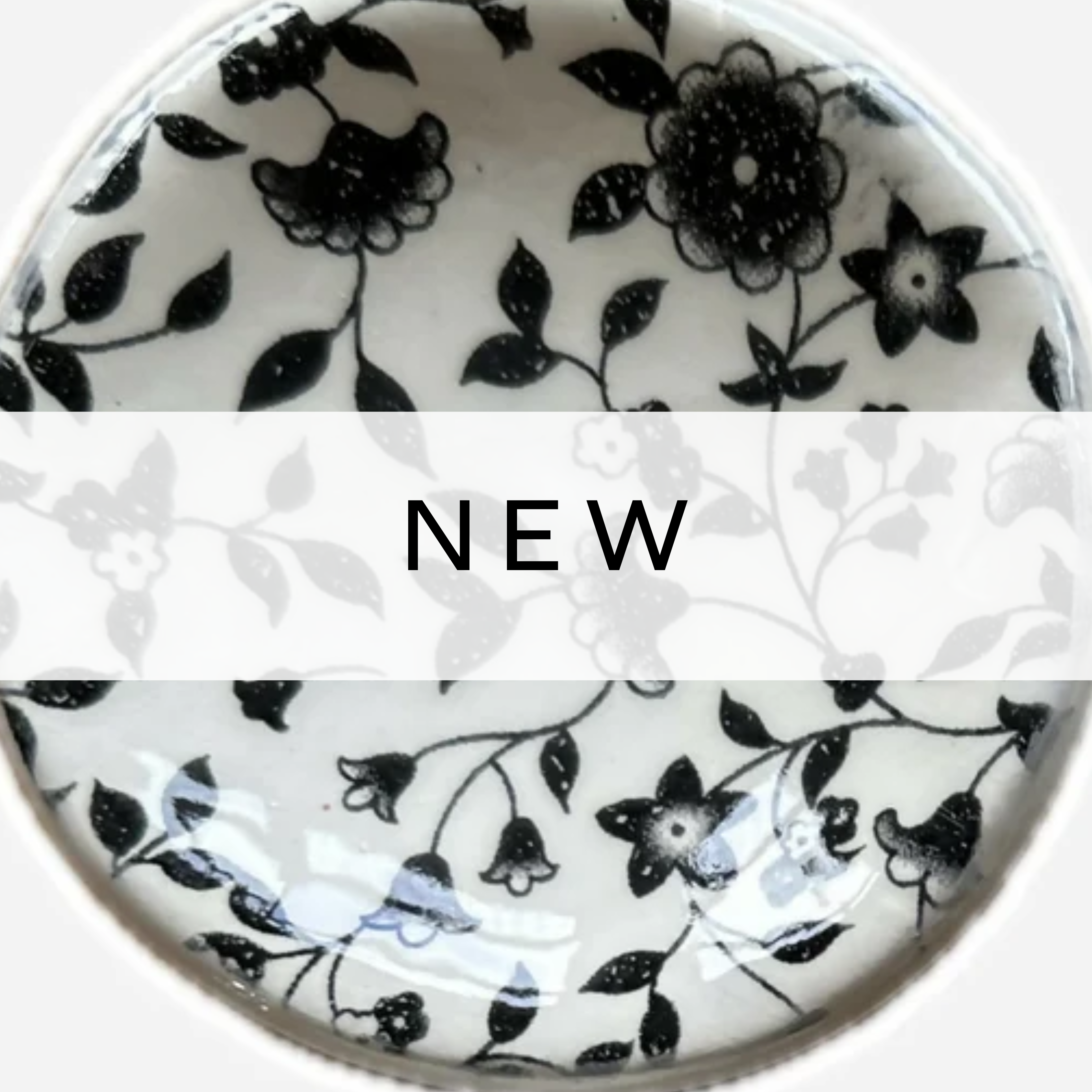 White ceramic bowl decorated with delicate black flower illustrations.
