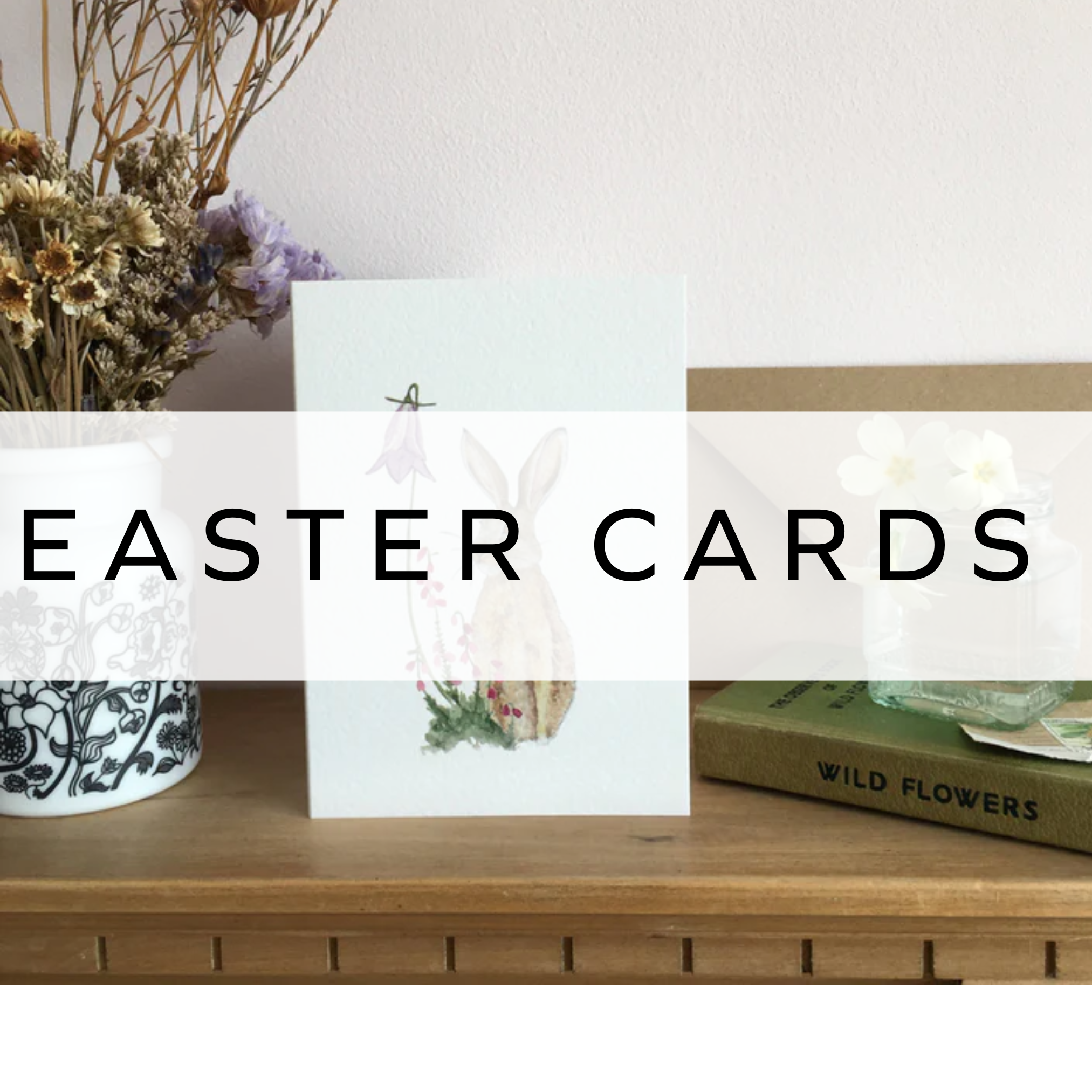 White Easter card featuring a hare design, resting on a wooden table.