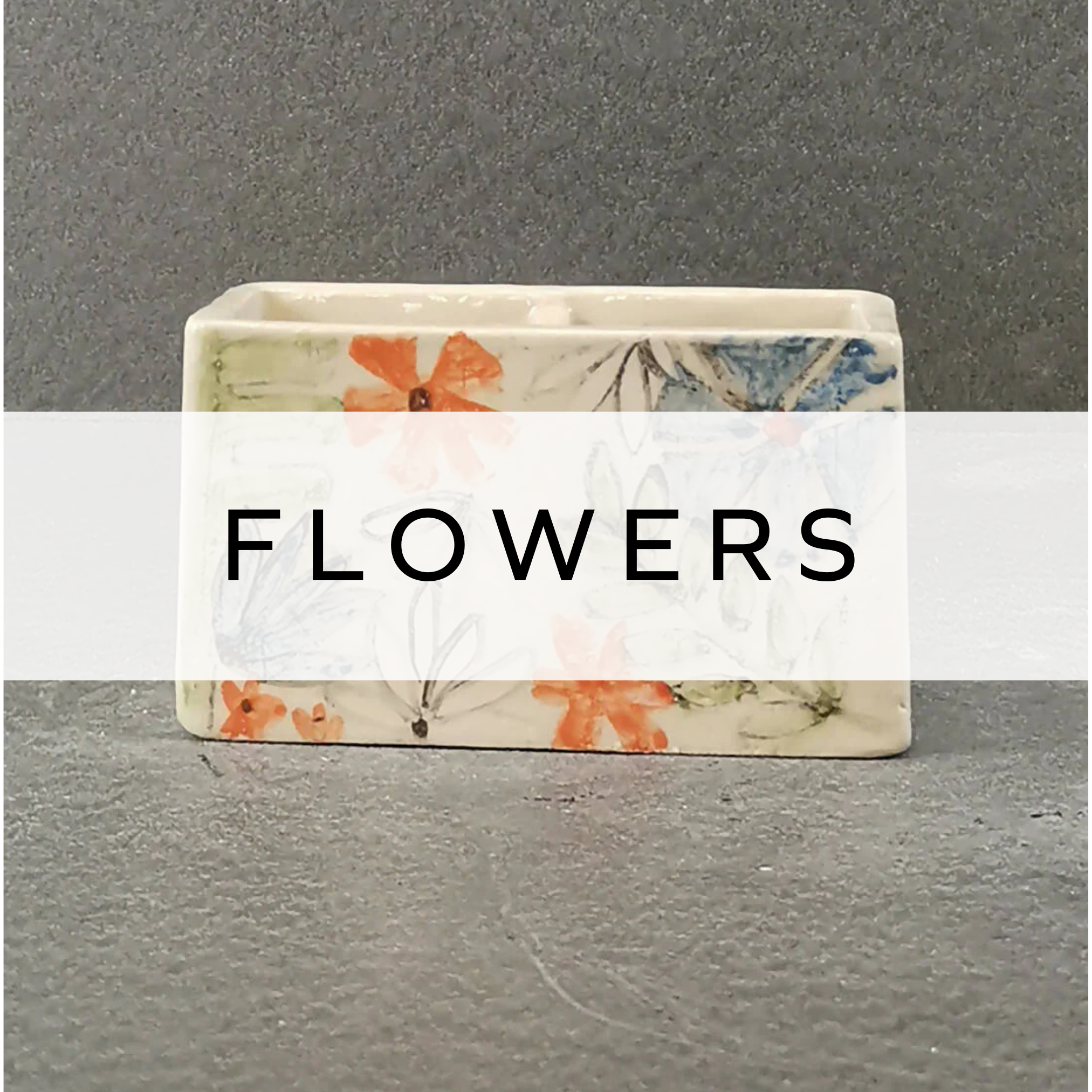 Square ceramic vase featuring vibrant orange and blue floral design, handcrafted pottery.