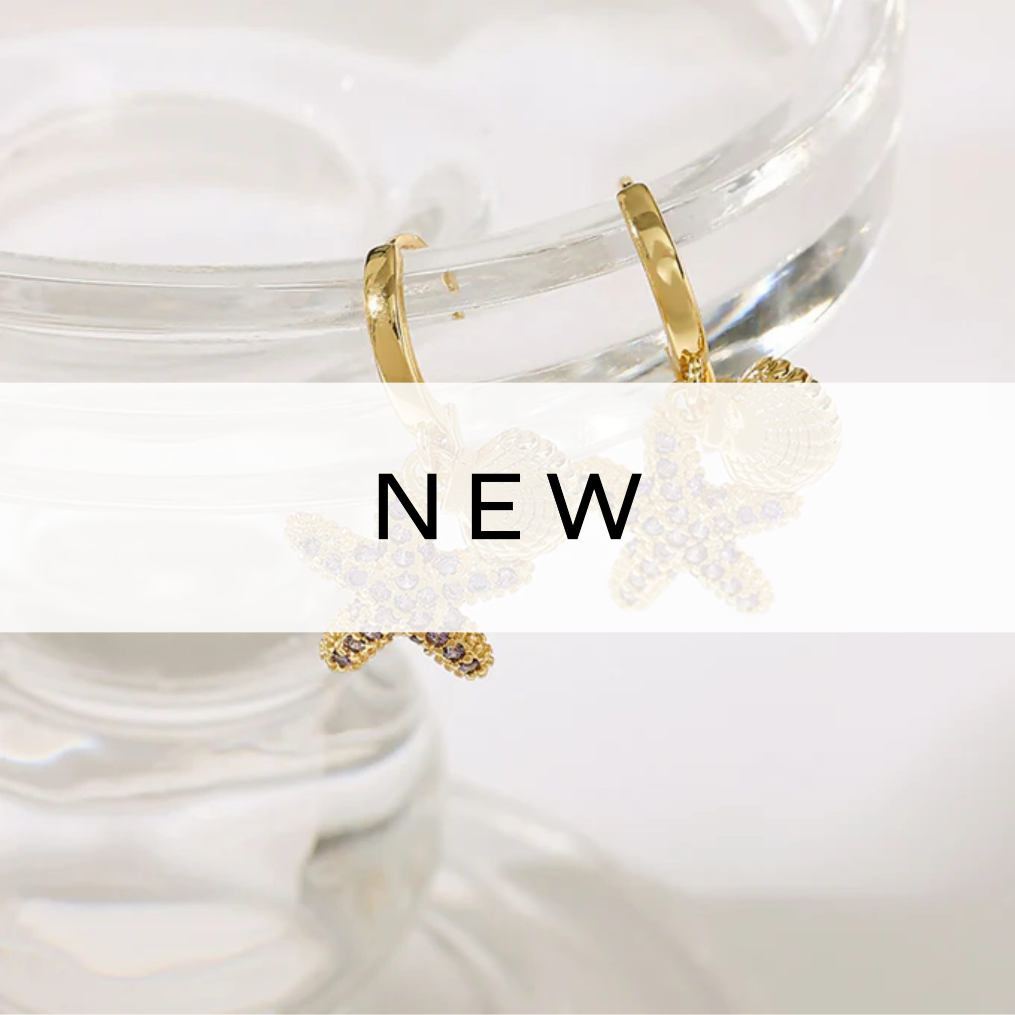 A pair of elegant gold starfish hoop earrings with a textured finish, beautifully crafted to add a touch of coastal charm and sophistication to any outfit.