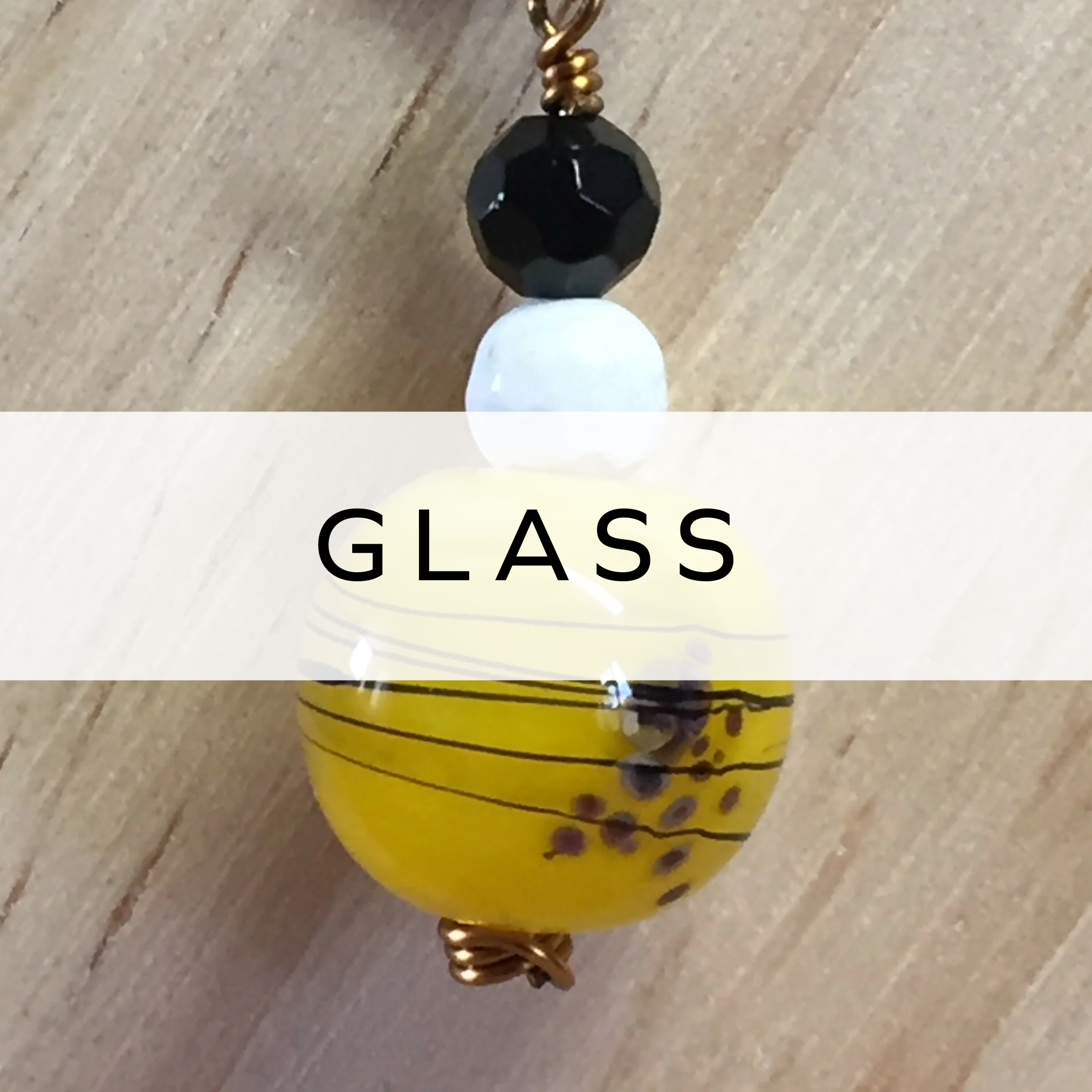 Close-up of a vibrant yellow and black glass bead necklace, showcasing bold, contrasting colours and a stylish design, perfect for adding a pop of colour to any outfit.