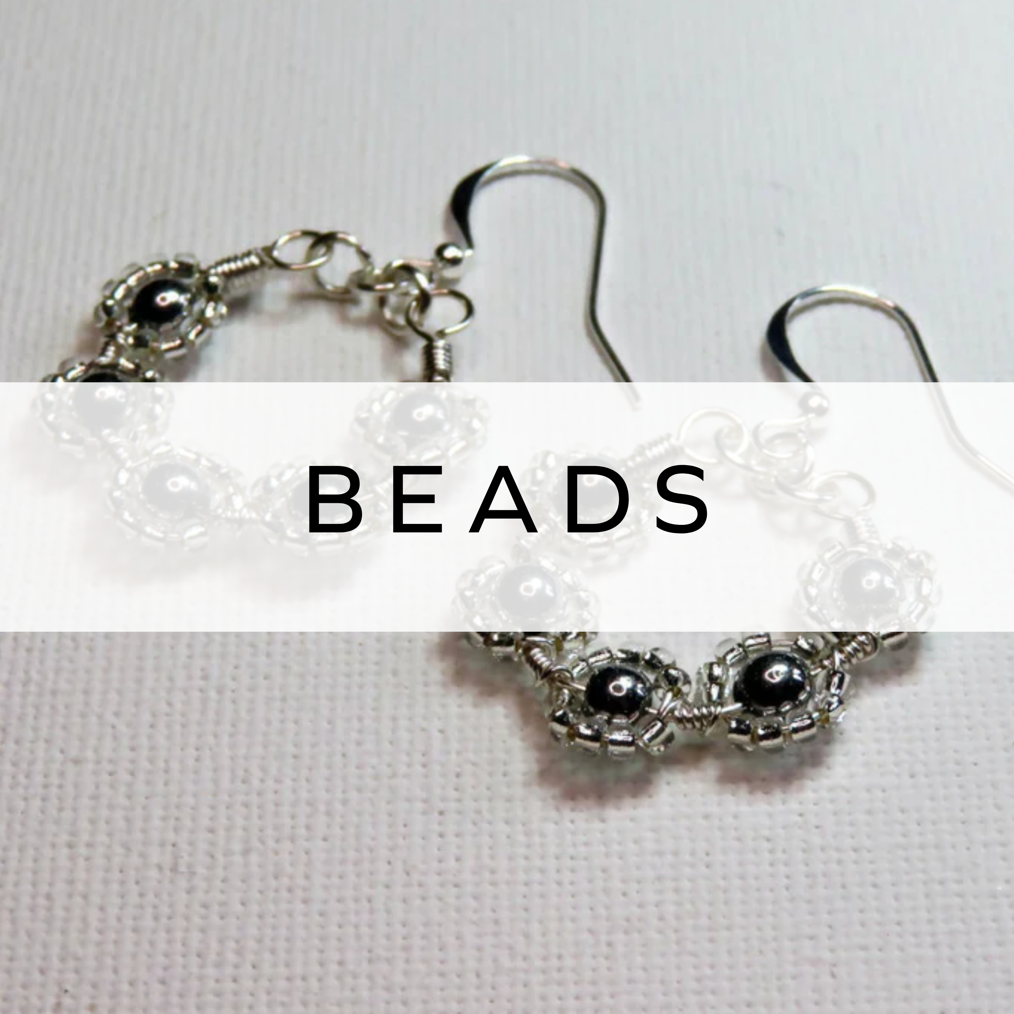 Silver beaded hoop earrings with intricate detailing – elegant and chic accessory.