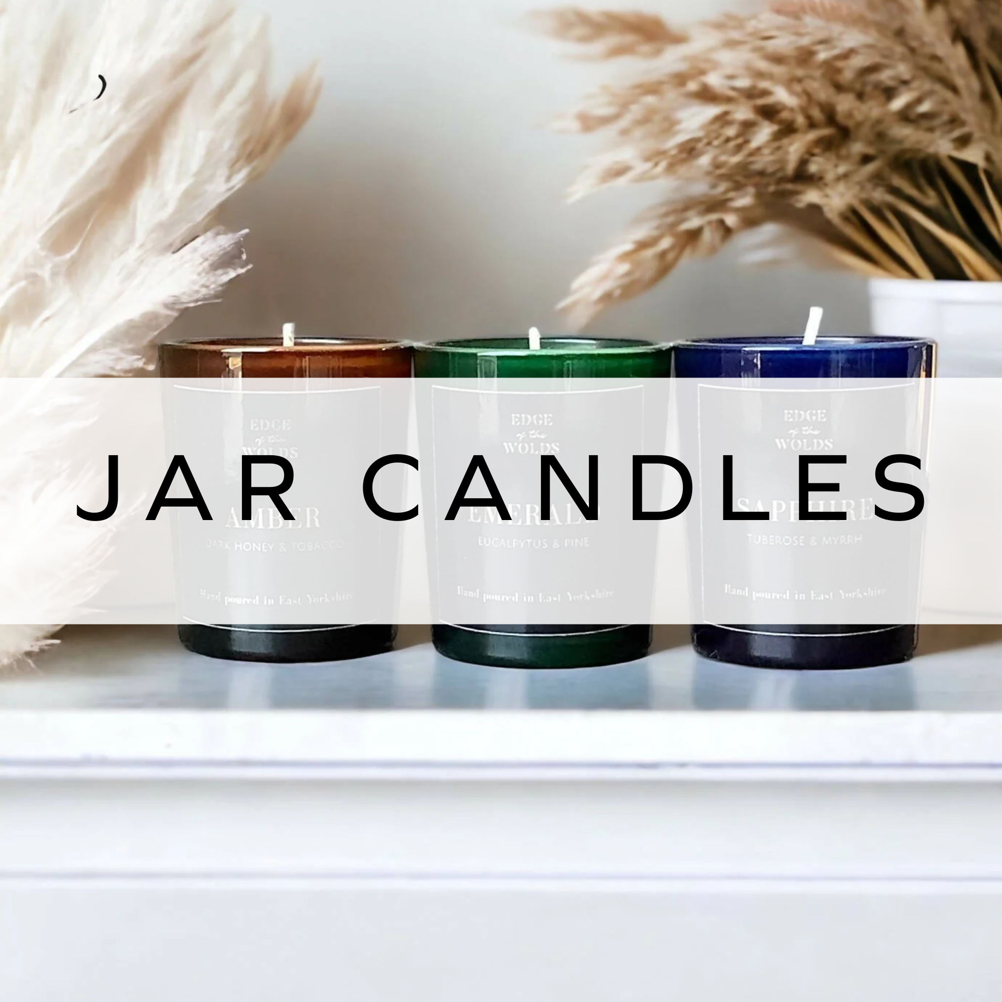 A trio of brown, green and blue candles.
