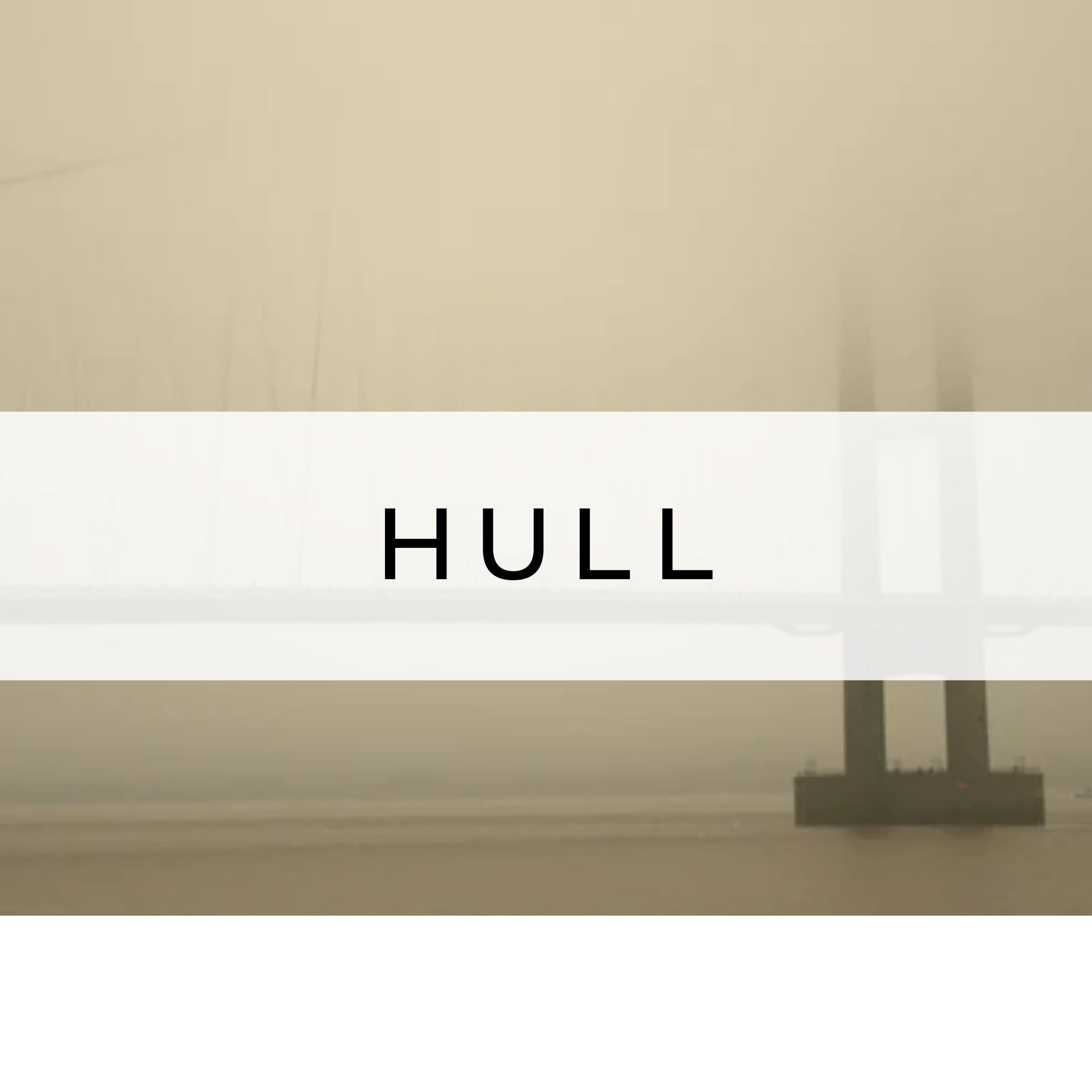 Photograph of the Humber Bridge shrouded in fog, with the structure partially hidden by mist, creating a mysterious and atmospheric scene.