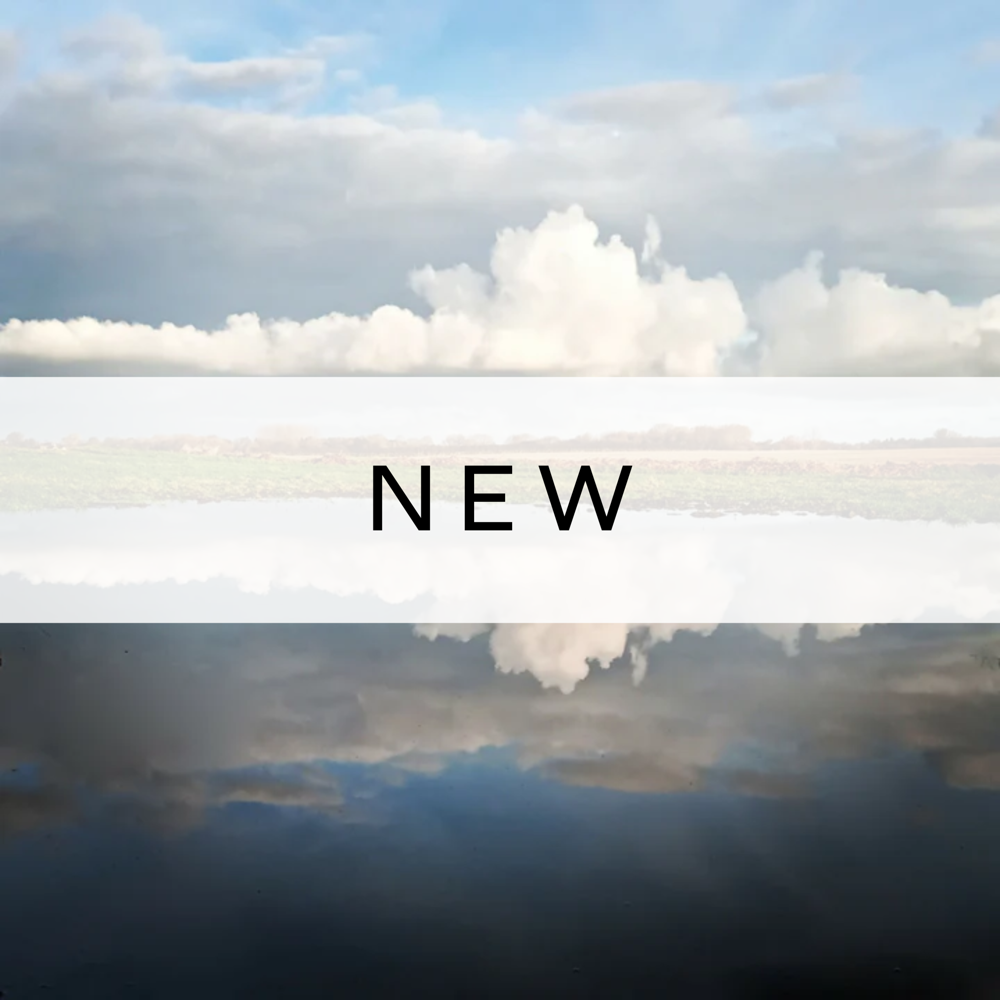 Photograph of soft clouds reflected on still water, creating a peaceful and dreamlike mirrored landscape.