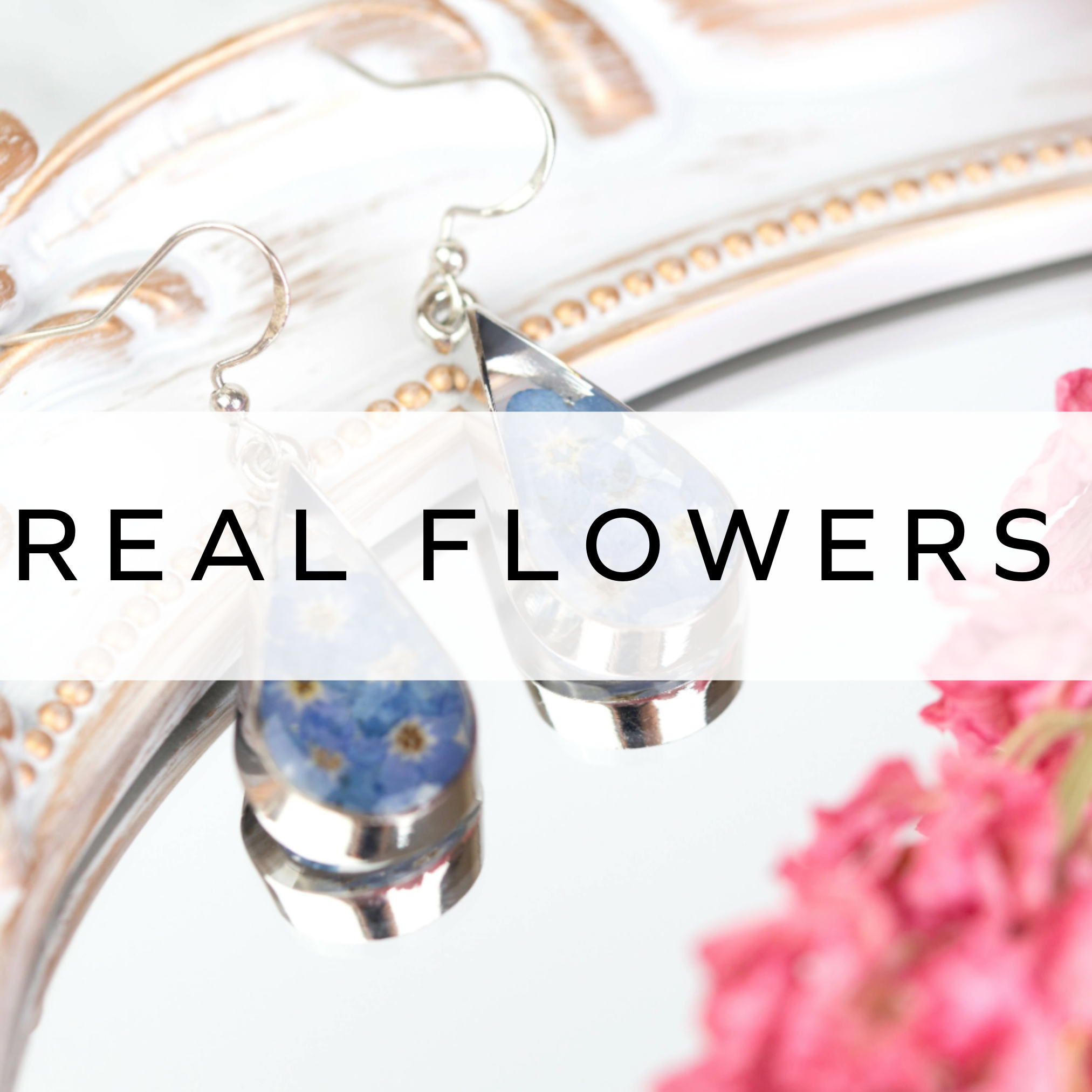 Silver teardrop earrings with blue flowers in.