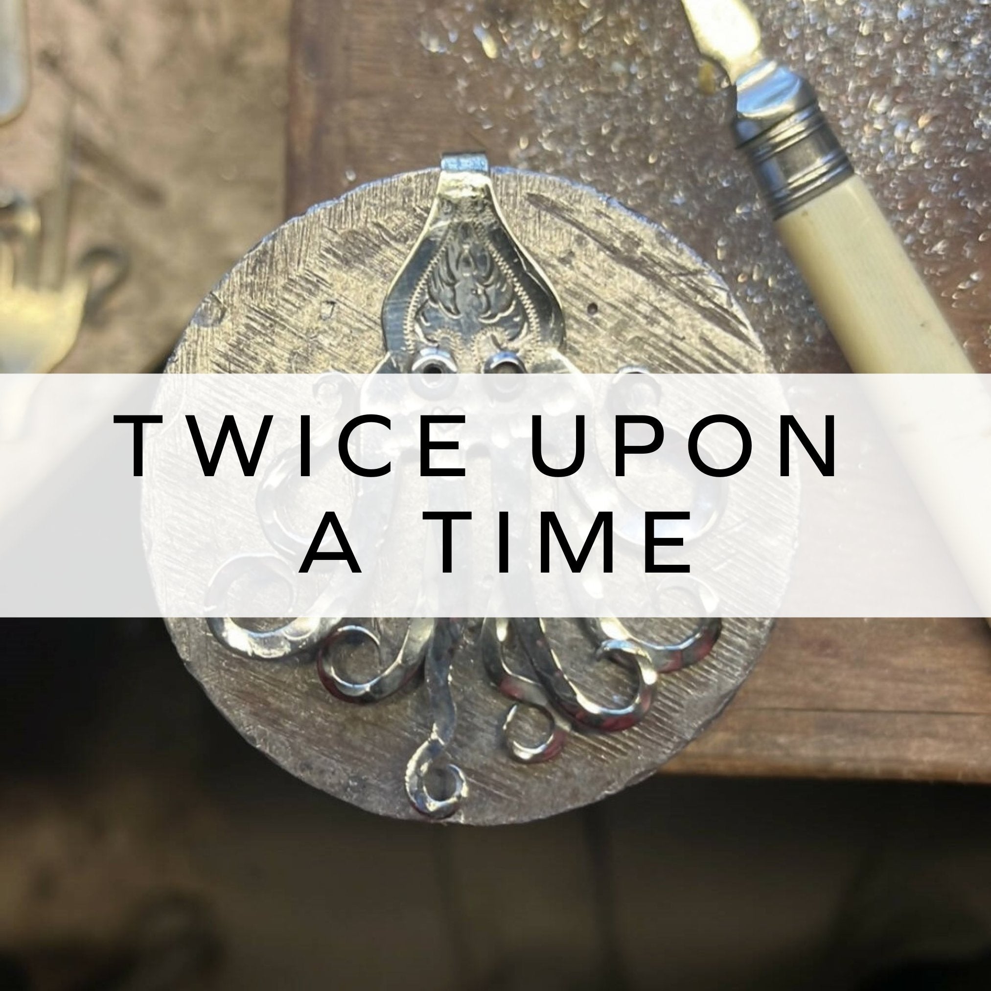 Pendant in the shape of an octopus, handcrafted from a vintage fork, showcasing intricate design and repurposed craftsmanship.