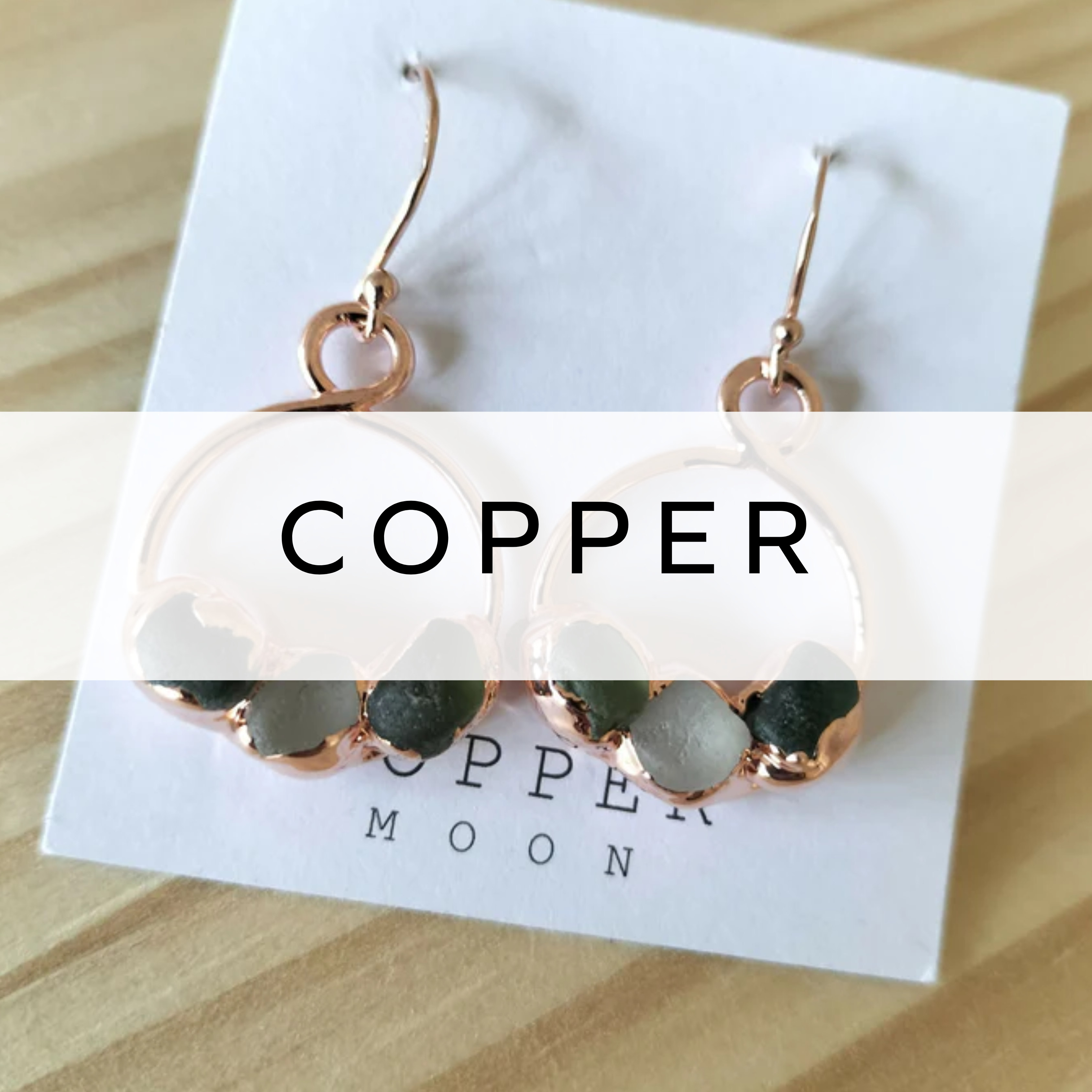 Handcrafted copper earrings featuring soft green sea glass, combining rustic metal with coastal charm for a natural, boho-inspired look.