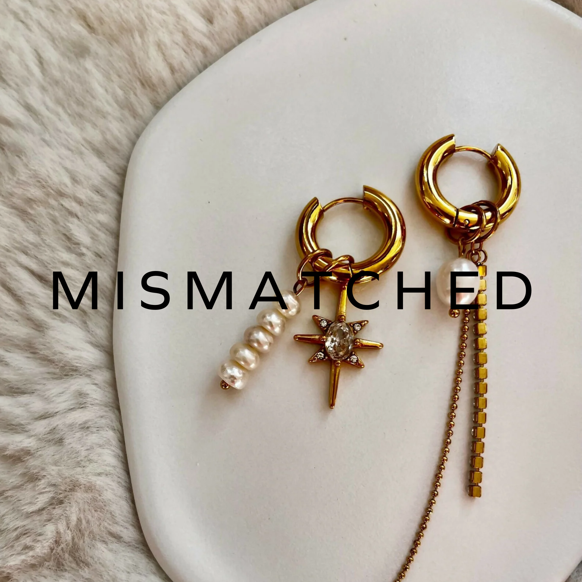 Gold hoop earrings with dangling pearls and delicate chain accents – elegant and modern statement jewellery.