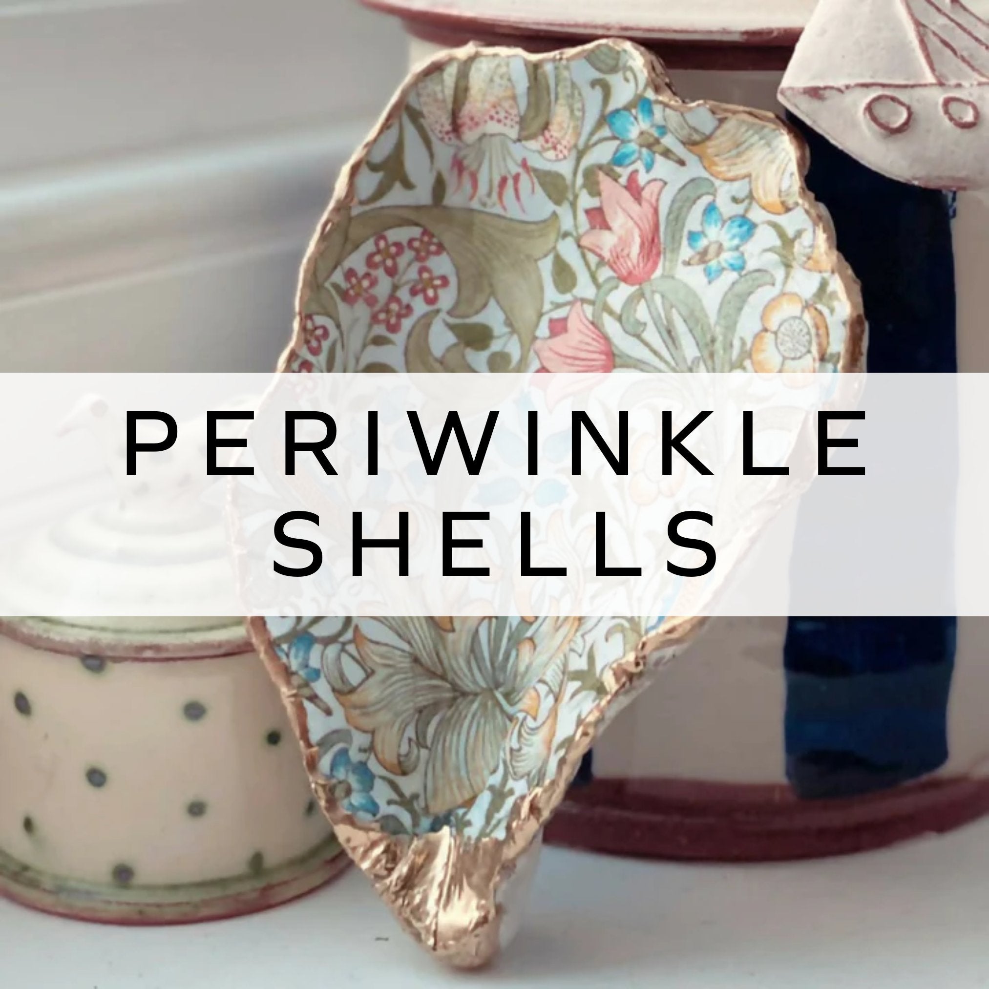 A decoupage shell featuring a William Morris pattern, showcasing intricate floral designs on the smooth surface of an oyster shell, blending art and nature.