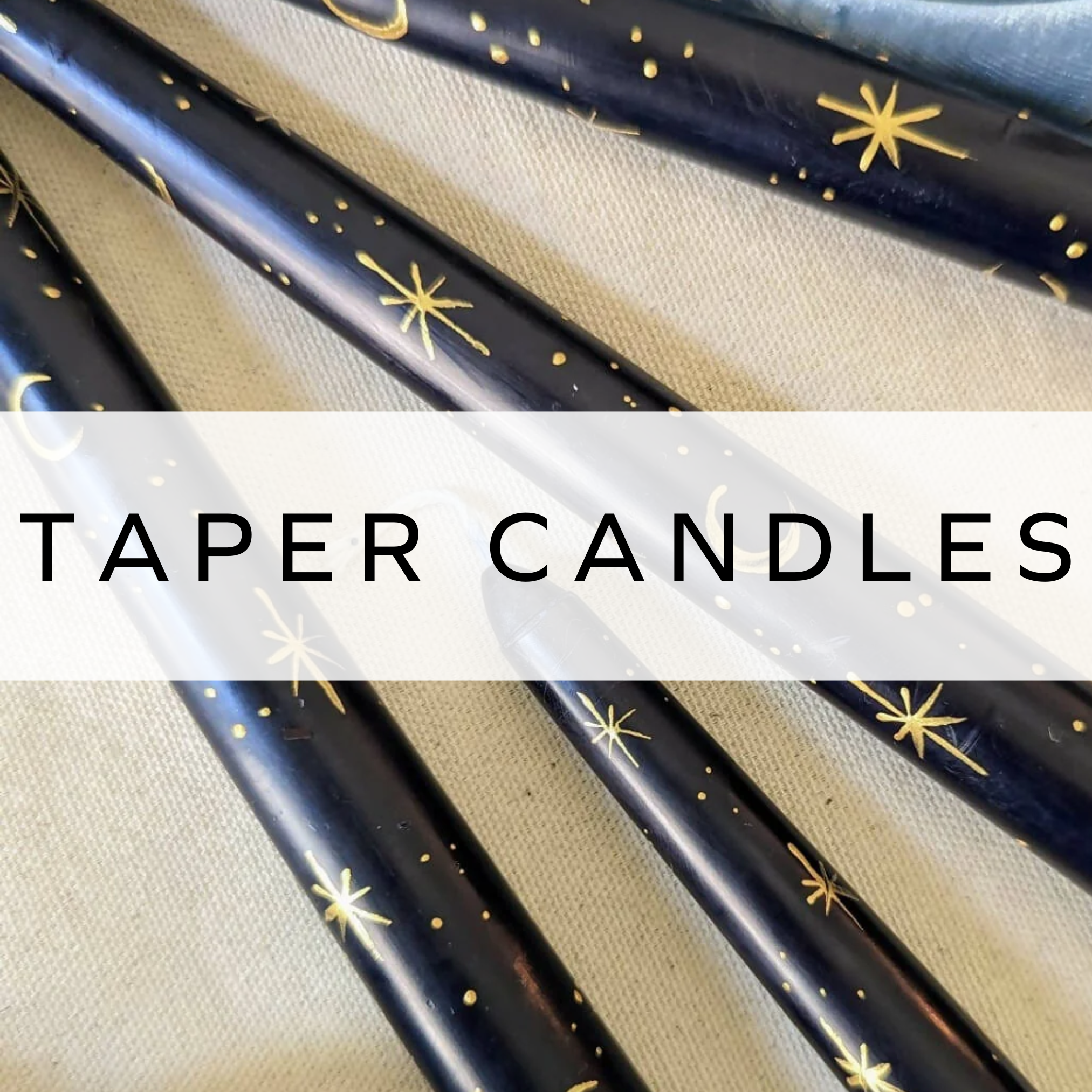 Dark blue taper candles with star and moon designs, perfect for a dreamy atmosphere.