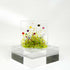 Glass tealight holder with floral design.