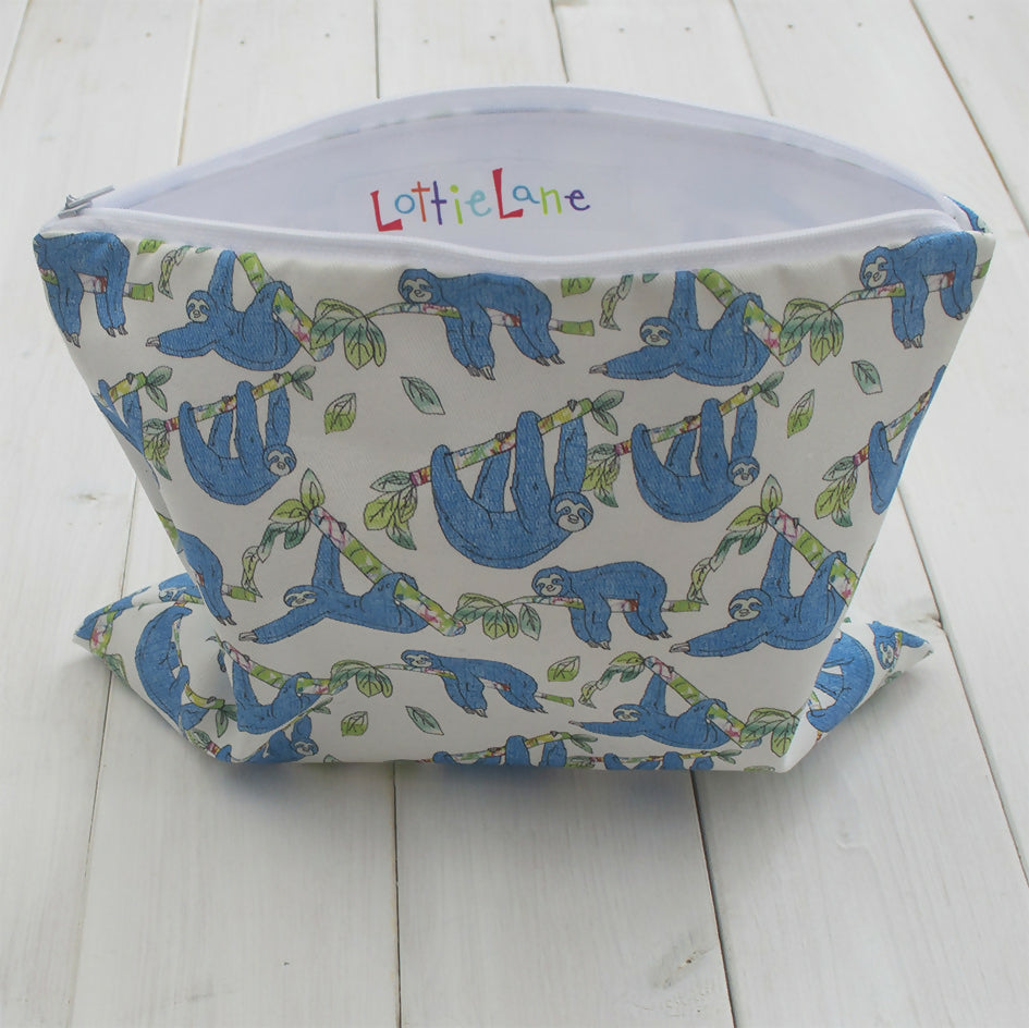 White wash bag with blue sloth design.