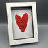 Poem in a red heart with white background and frame.