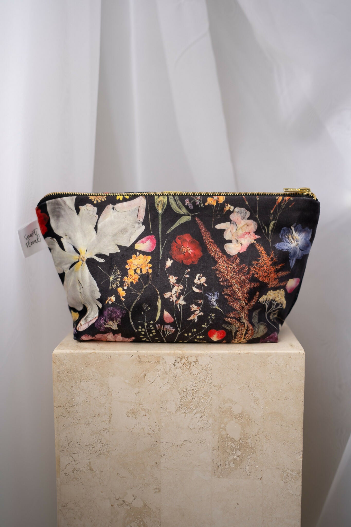 Black wash bag with floral design.