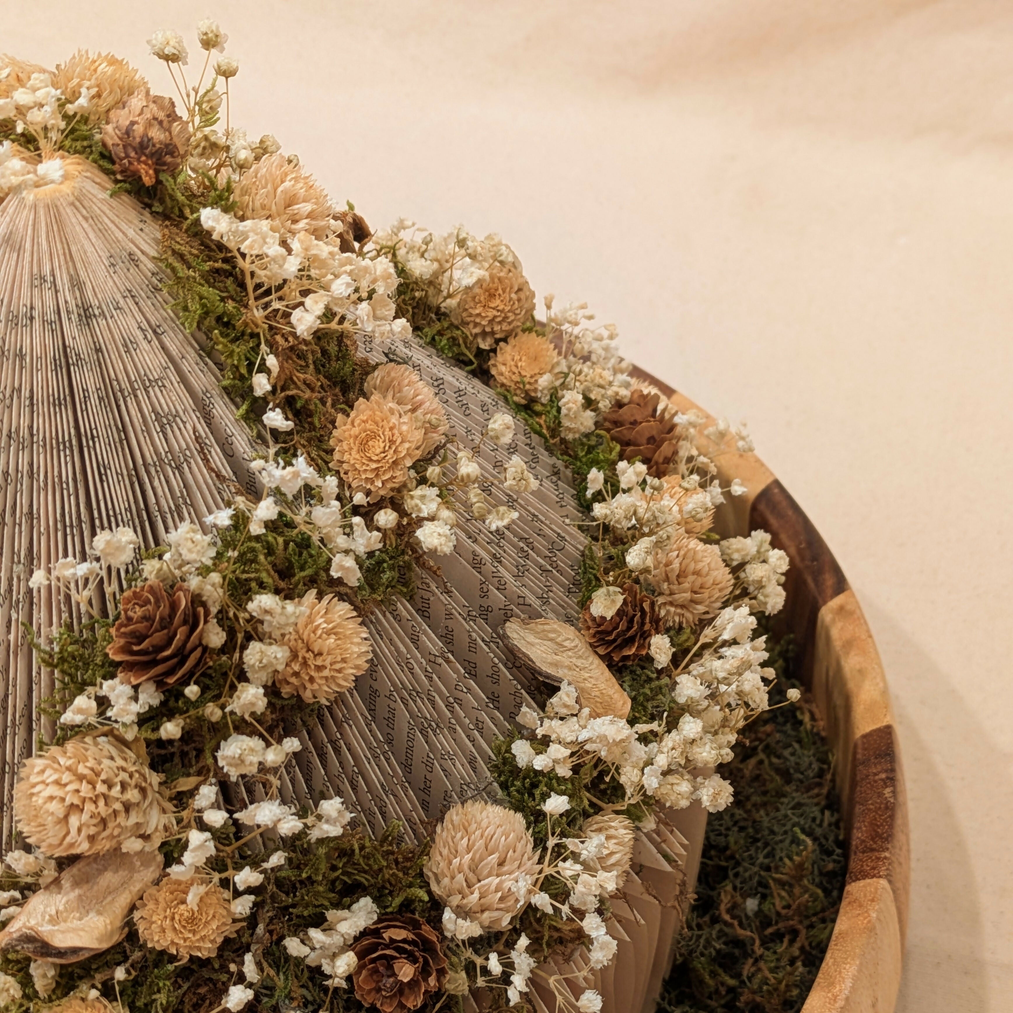 Warm Floral Arrangement on Circular Book in Wooden Tray