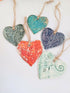 Multicoloured ceramic hanging hearts.