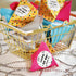 Colourful lucky dip bags in a gold basket.