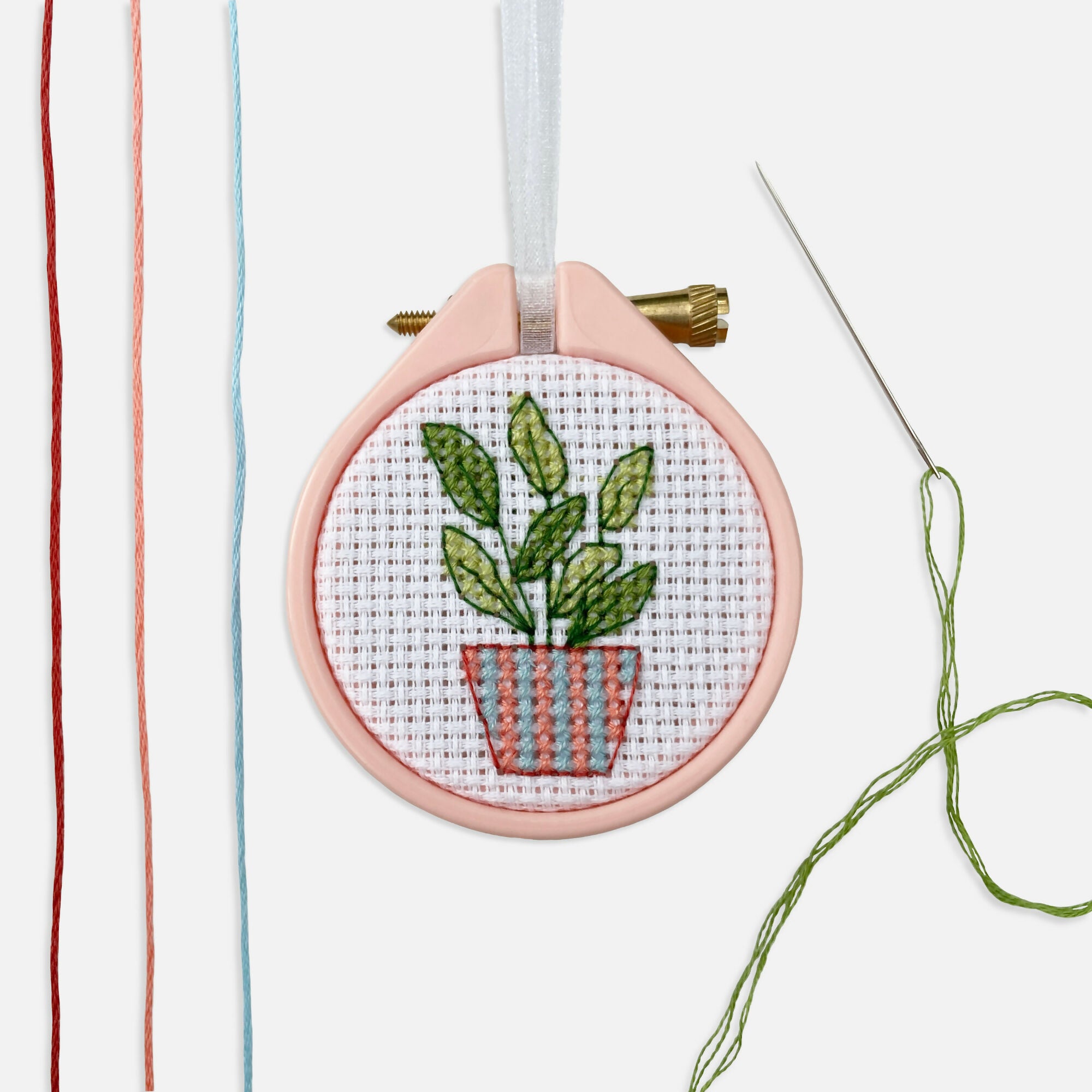 Stitched plant on embroidery hoop.