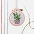 Stitched plant on embroidery hoop.