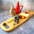 Large oak charcuterie board with fruit and cheese displayed on it.