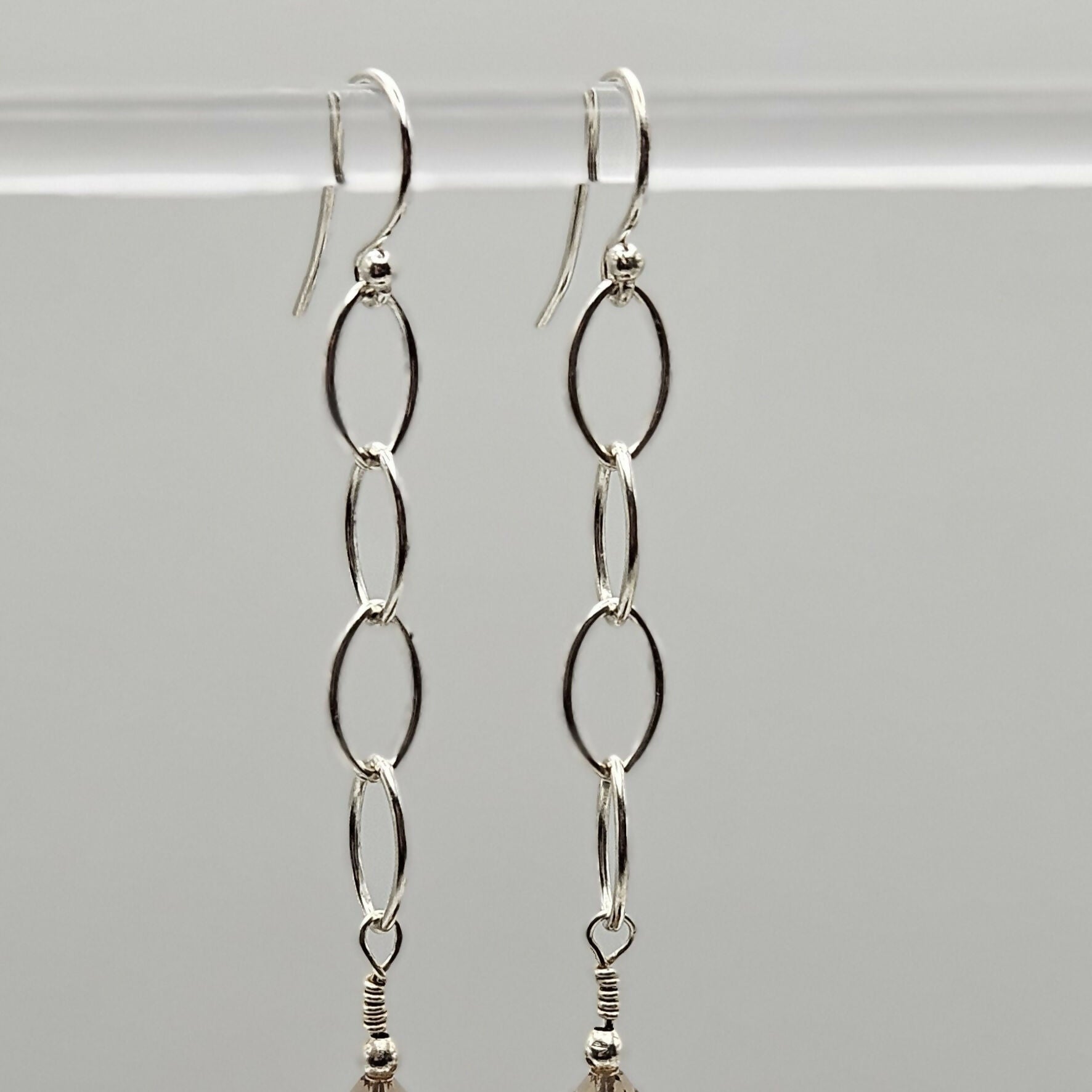 HAND LAMPWORKED GLASS HUMBUG EARRINGS, WITH STERLING SILVER CHAIN , STERLING SILVER EAR WIRES AND SWAROVSKI CRYSTALS.