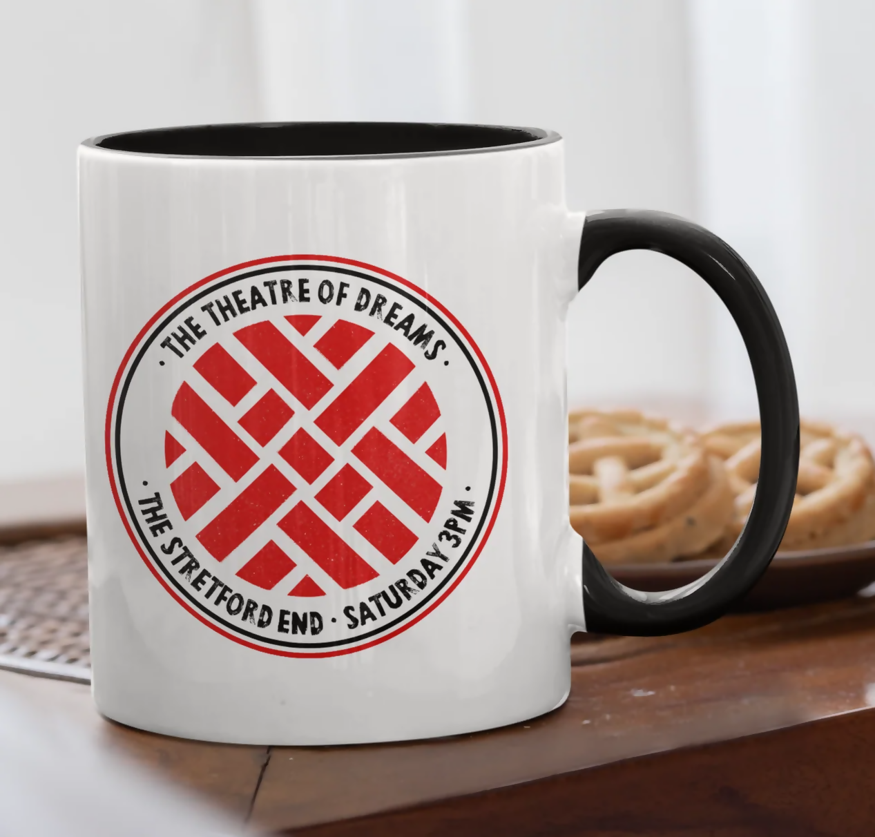 White mug with red knot design.