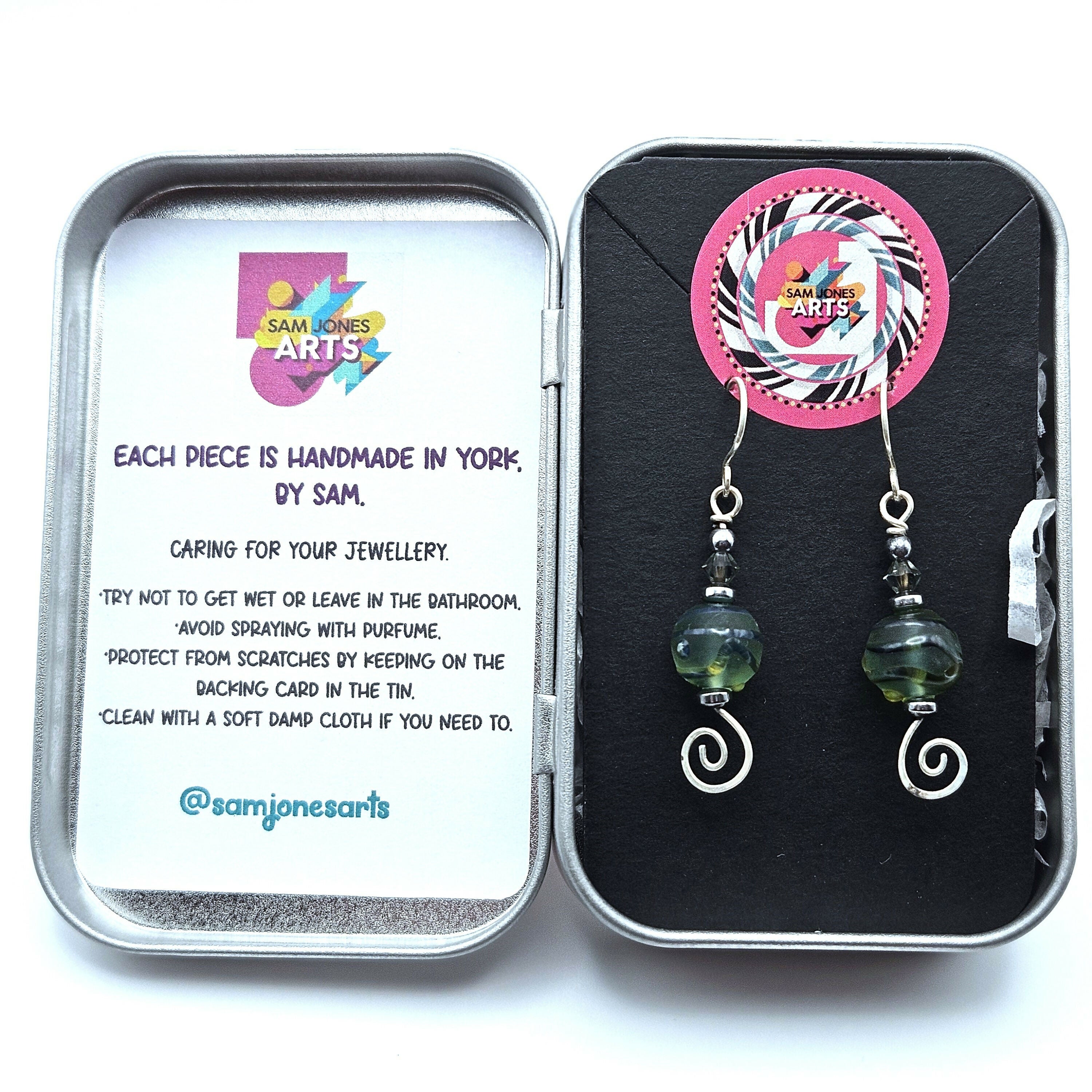 HAND LAMPWORKED GLASS SWIRL EARRINGS, WITH AN ETCHED FINISH, HAND FORMED STERLING SILVER WIRE WORK, STERLING SILVER EAR WIRES AND SWAROVSKI CRYSTALS.