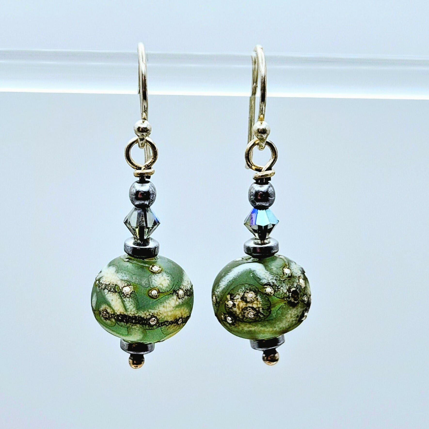 HAND LAMPWORKED GLASS EARRINGS, WITH AN ETCHED FINISH,STERLING SILVER EAR WIRES AND SWAROVSKI CRYSTALS.