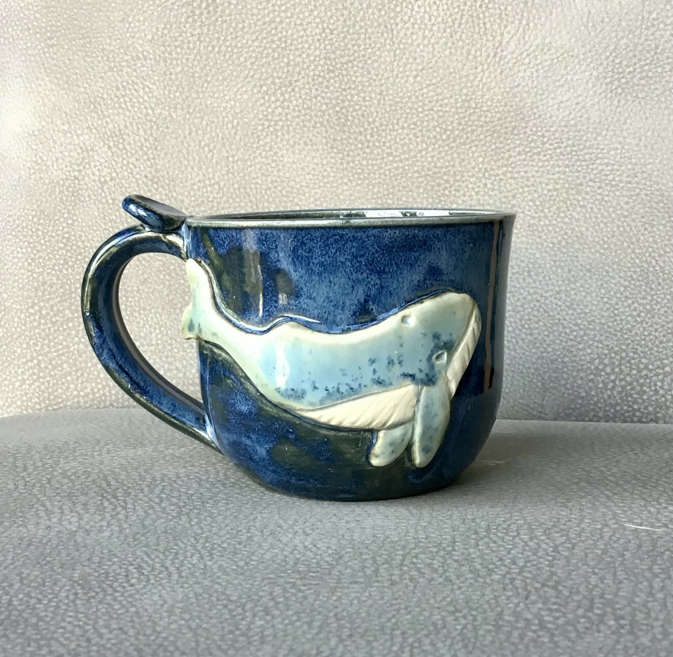Blue ceramic mug with a whale on.