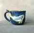 Blue ceramic mug with a whale on.