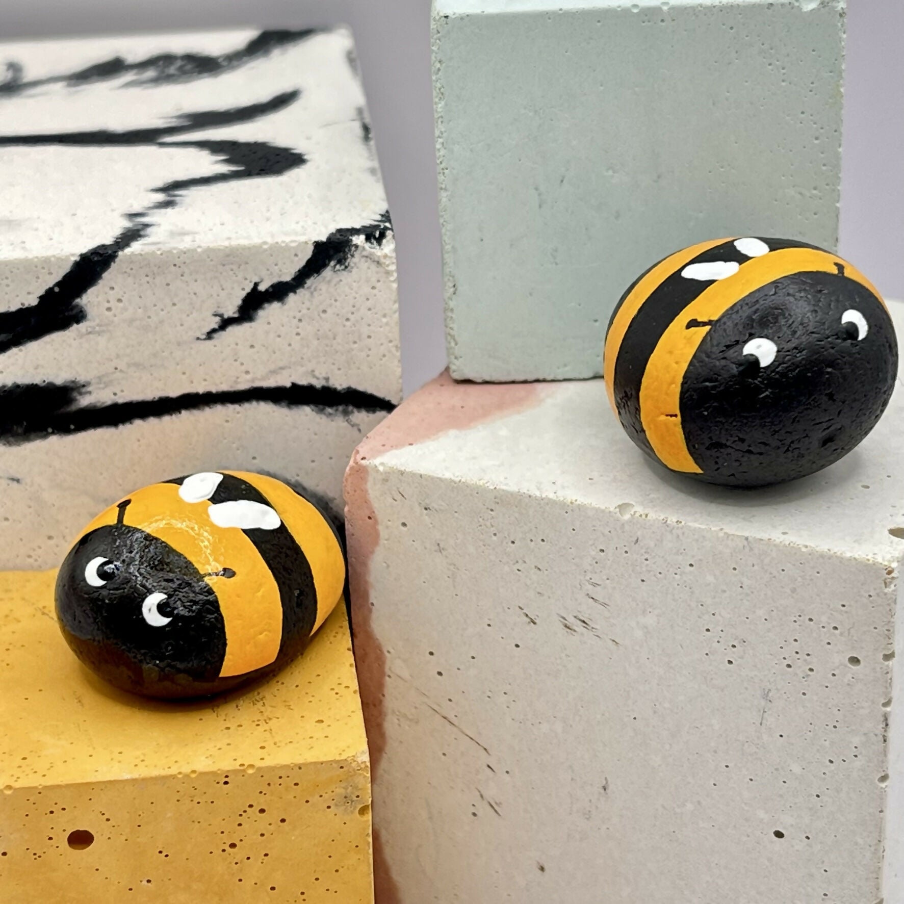 Painted pebble as a bee.