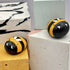 Painted pebble as a bee.