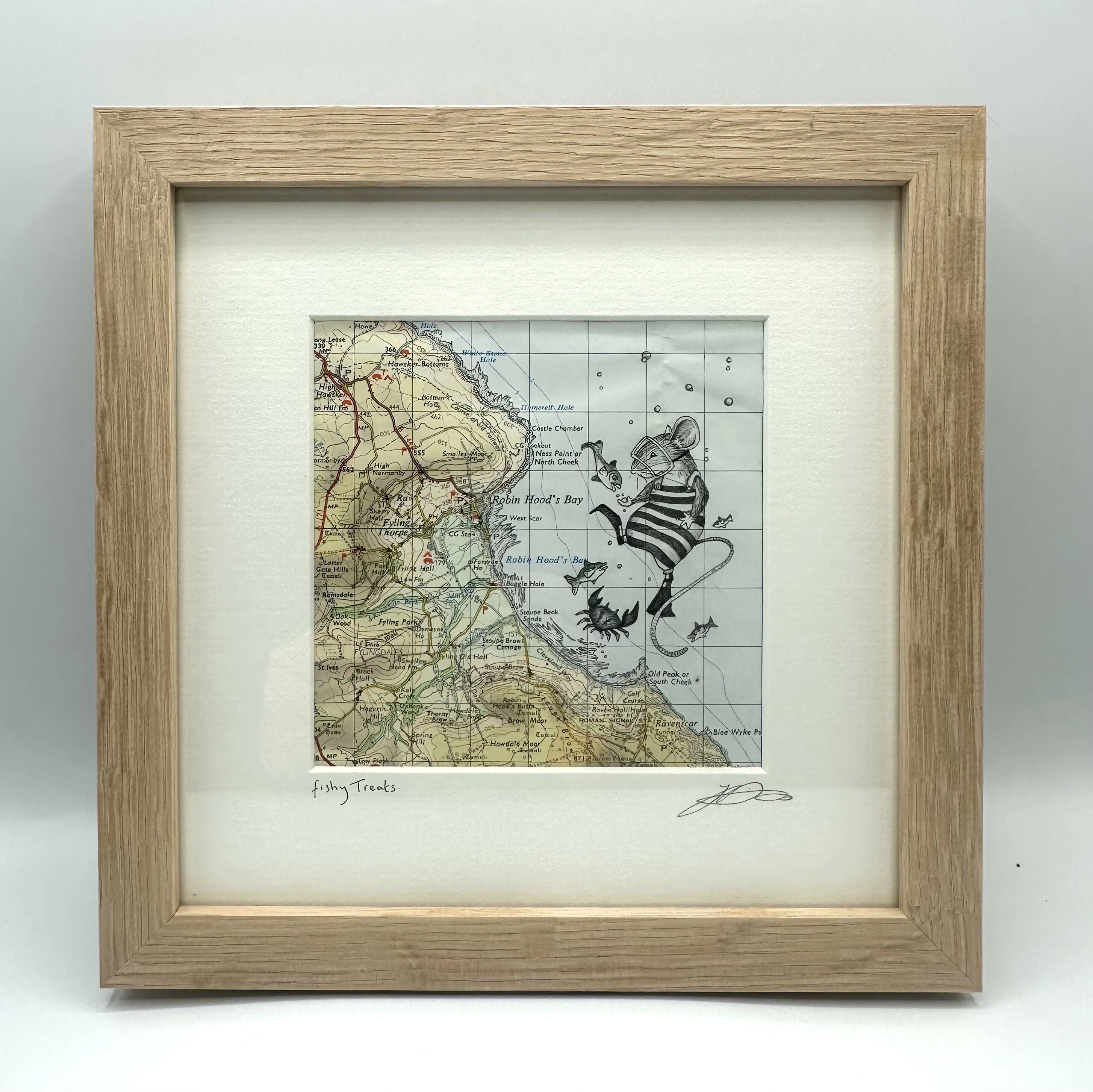 Pen drawing of a mouse with fish off the shore of Robin Hood's Bay on an original map, framed.
