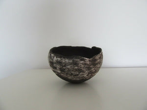 Black stoneware rocking pot