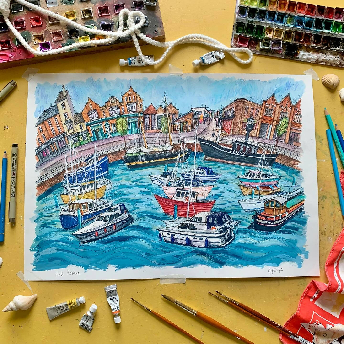 Painting of Hull Marina with paint and brushes around it.