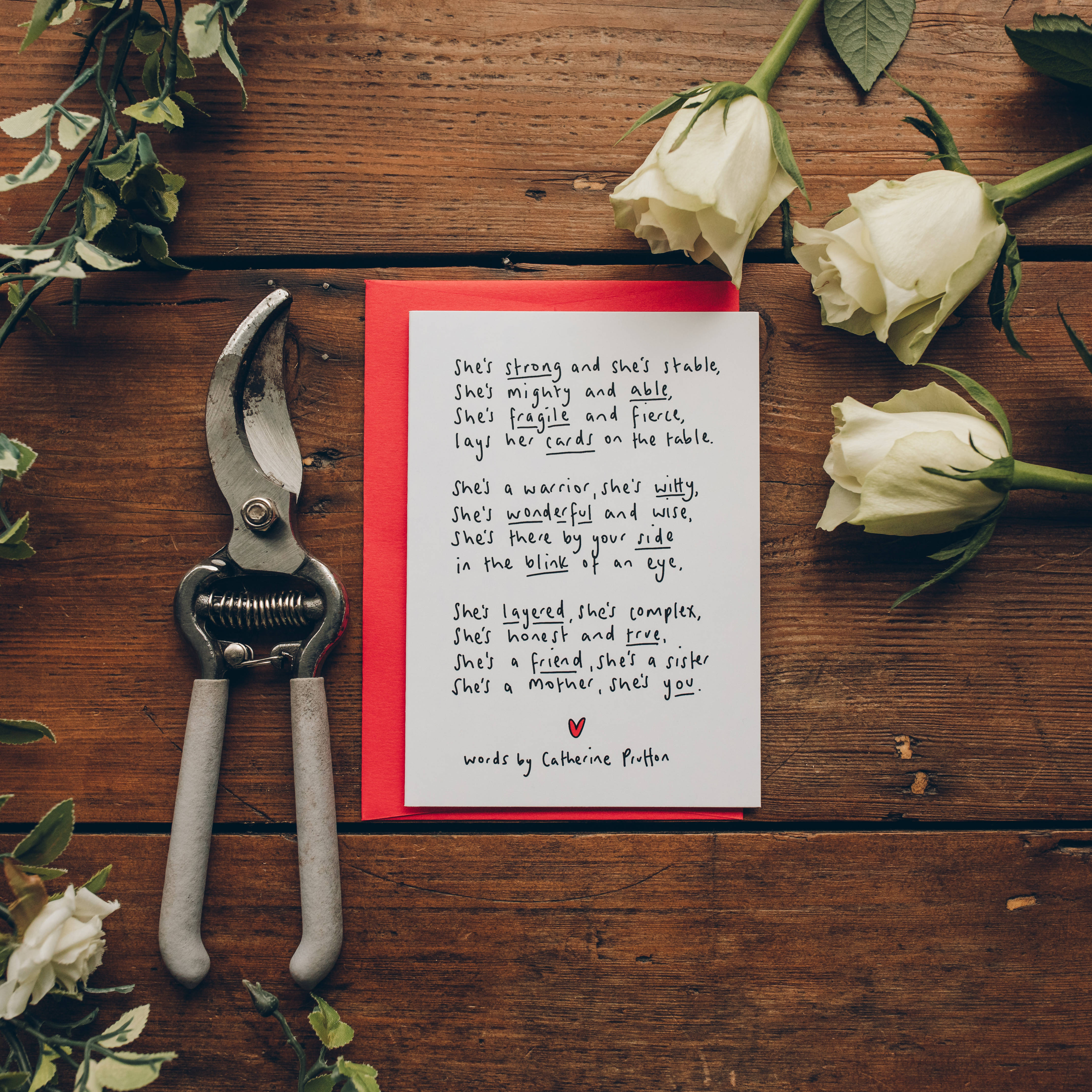 Black and white poem on a card with red heart.