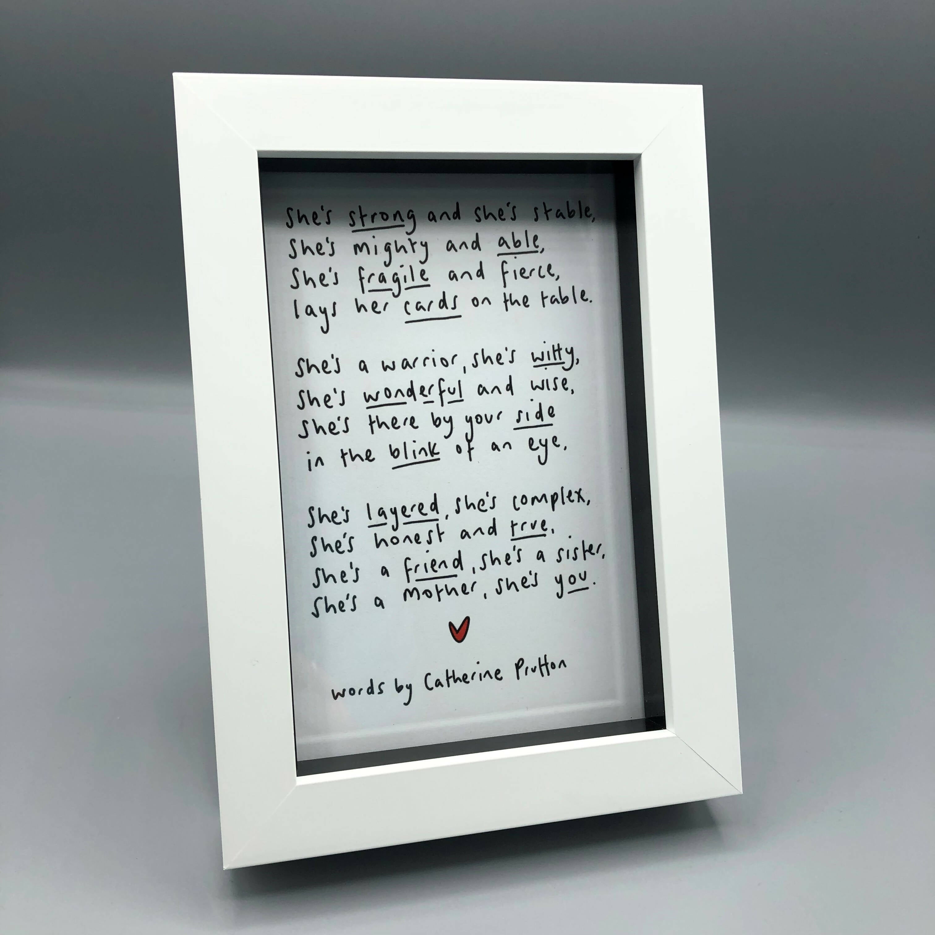 Black and white poem with red heart in a white frame.