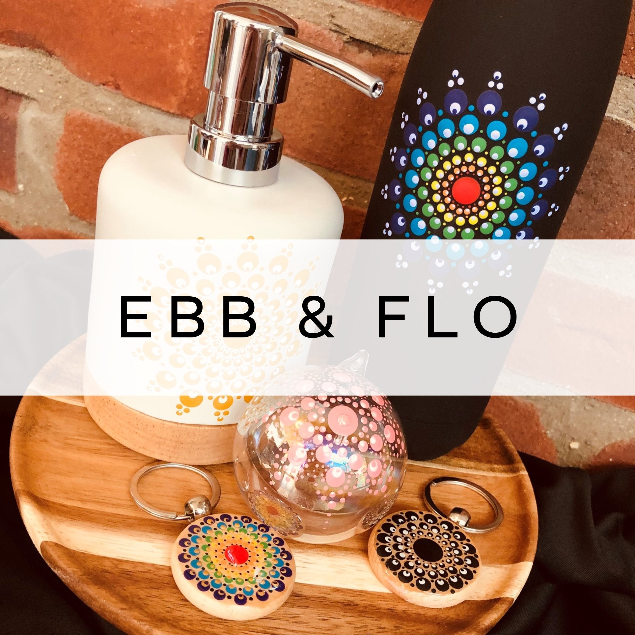 Hand-painted thermal water bottle with a vibrant rainbow mandala, alongside a glass bauble, keyrings, and a soap dispenser, each adorned with colourful mandala designs.