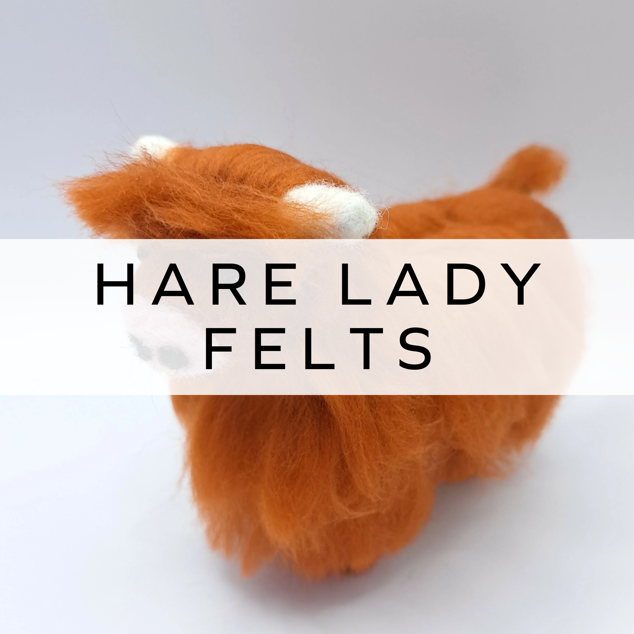 Handcrafted needle felted Highland cow figure with detailed wool texture, showcasing its shaggy coat, curved horns, and expressive features in a lifelike design.