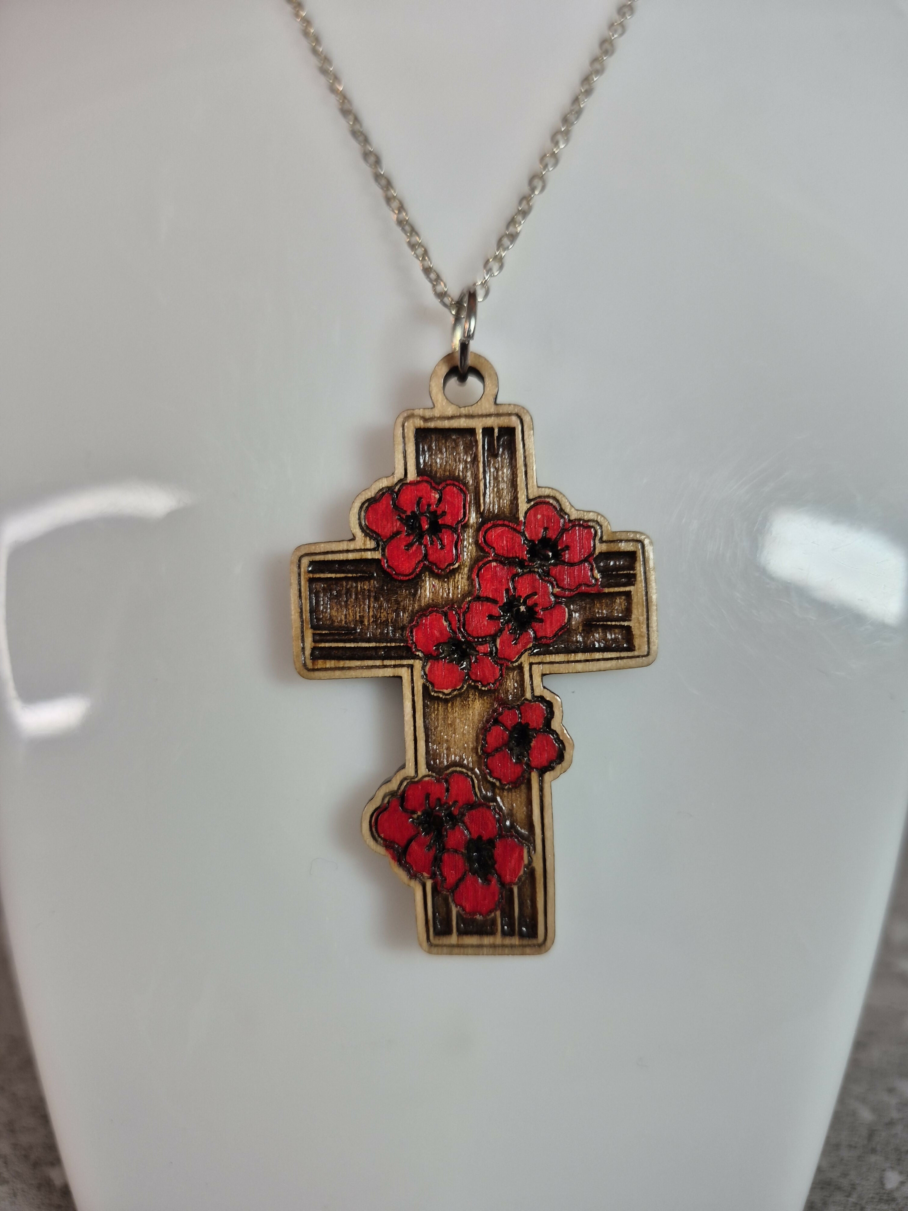 Handcrafted and engraved red poppy cross.