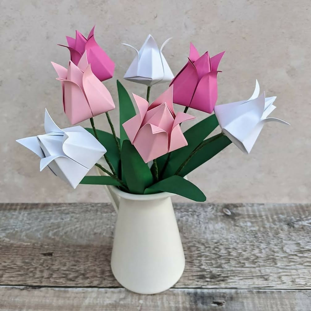 bouquet of seven origami tulips in pinks and white with green paper leaves