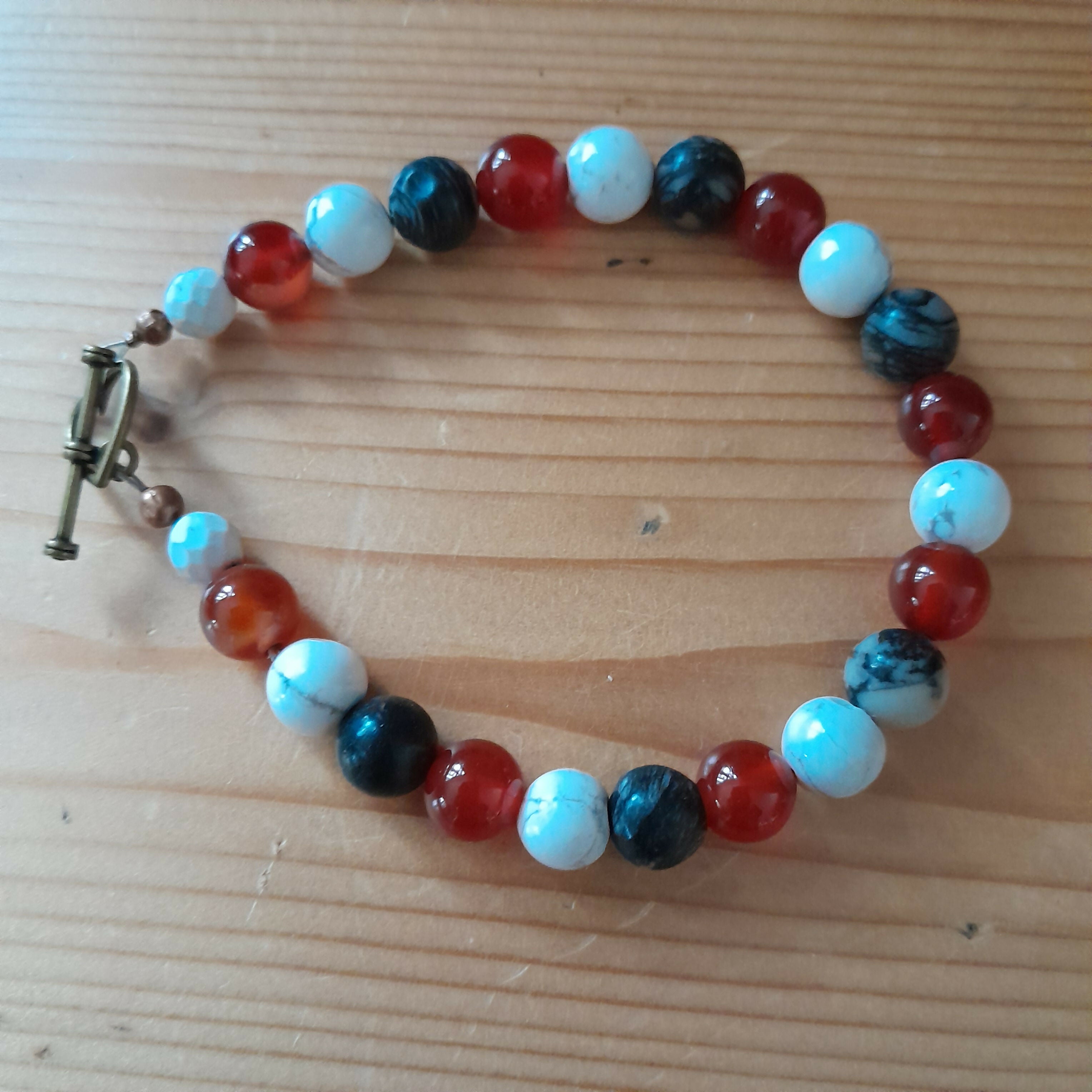 Bronze Toggle Catch Bracelet with Faceted Howlite, Carnelian, Polished Howlite and Black Silkstone.