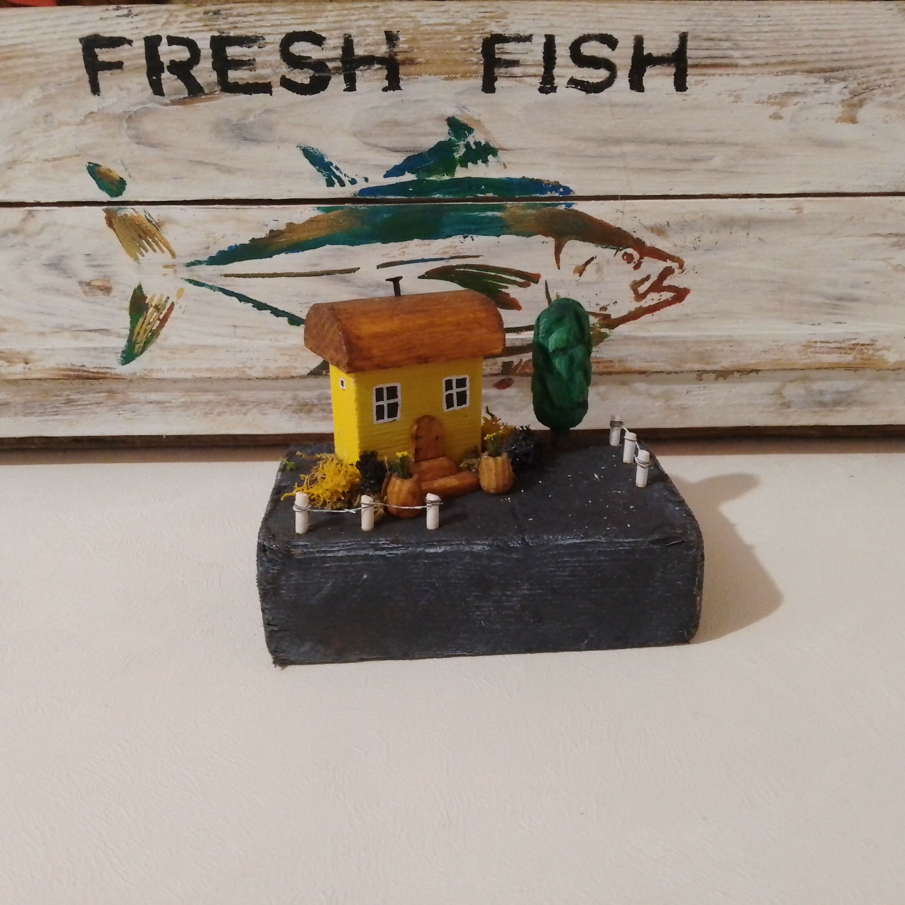 Small Yellow House with Plants, on Driftwood