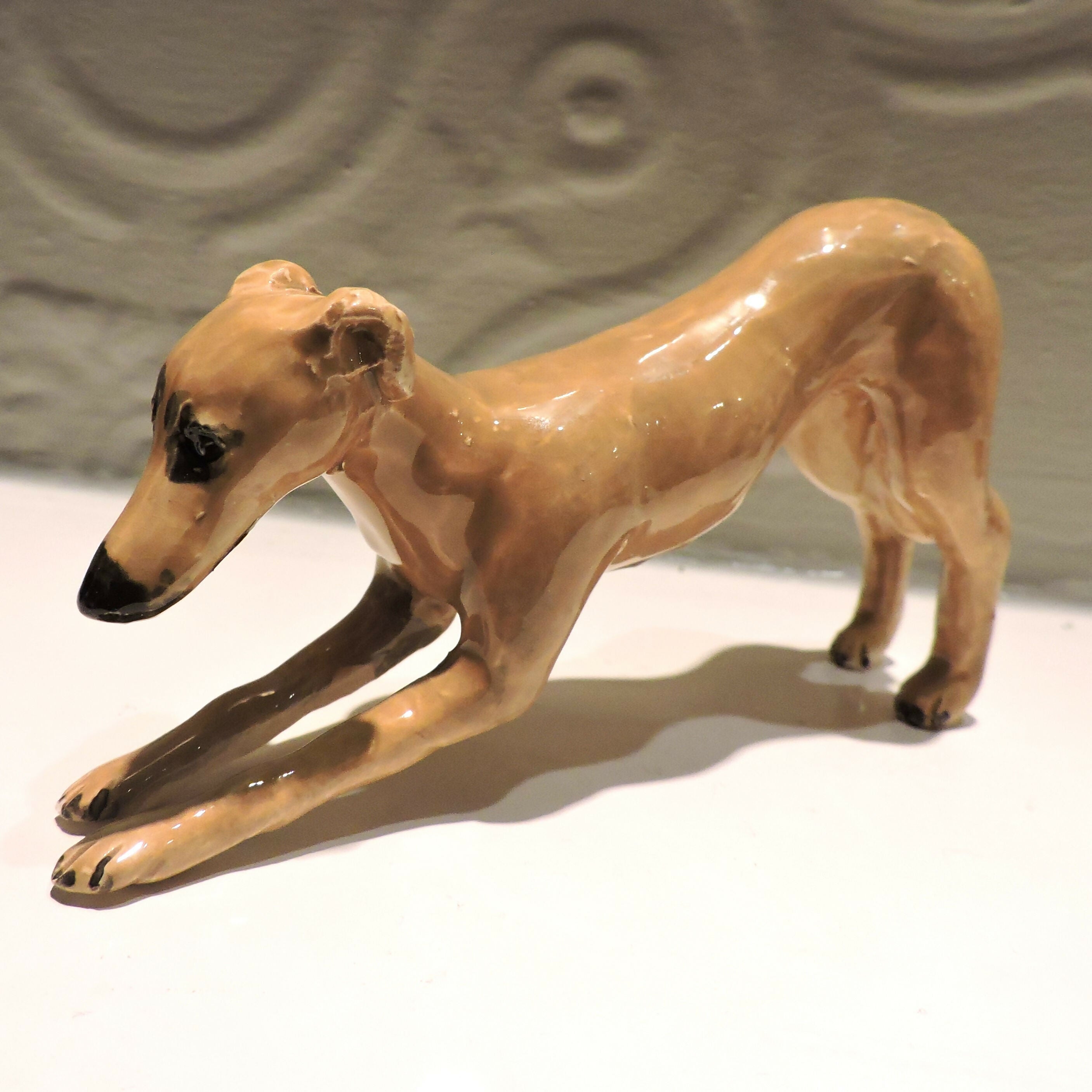 Ceramic Stretching whippet dog sculpture, fawn
