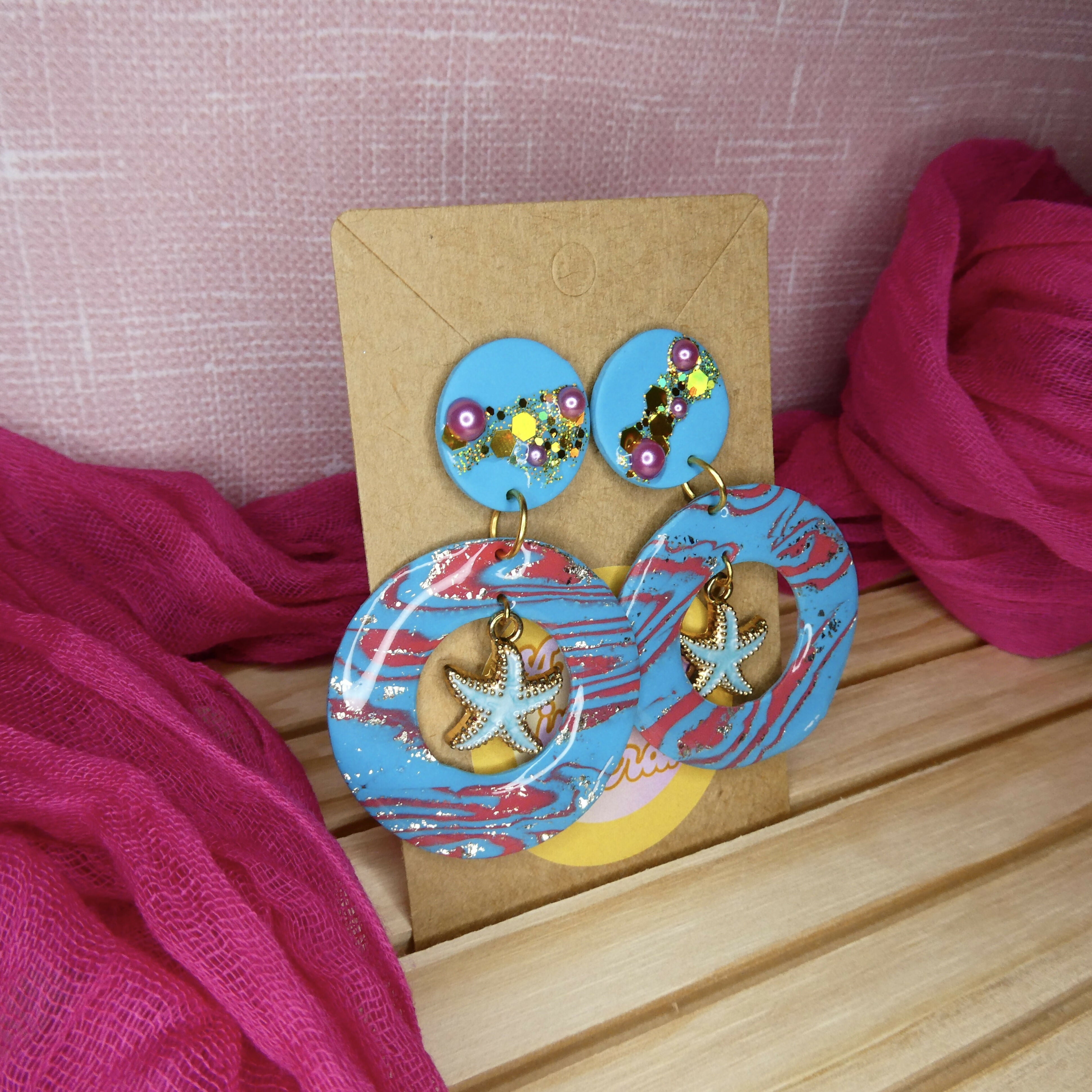 Blue Polymer Clay Earrings With Multicoloured Glitter And Blue Starfish Charm
