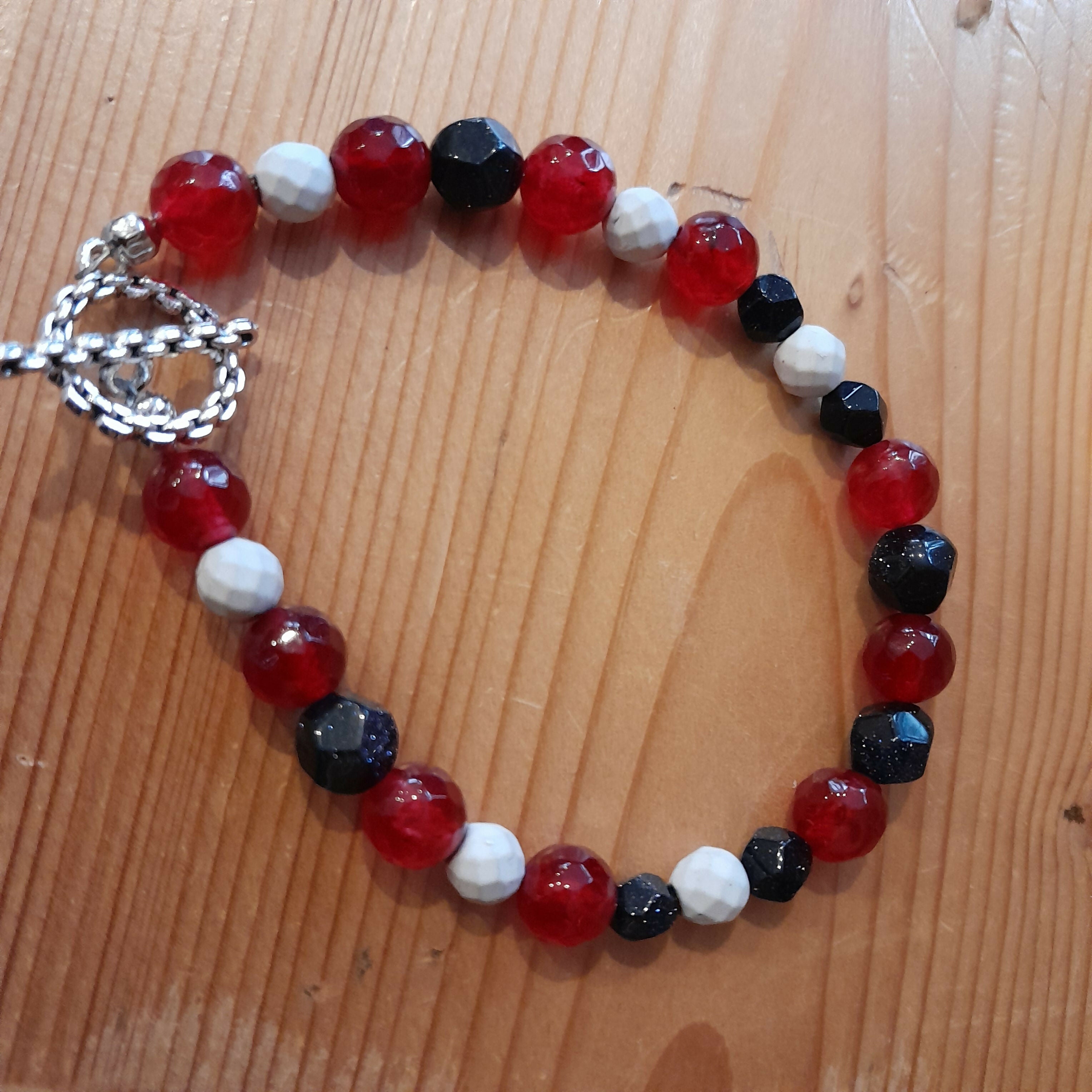 Tibetan Silver Toggle Catch Bracelet with Faceted Red Chalcedony, Faceted Howlite and Faceted Navy Goldstone.