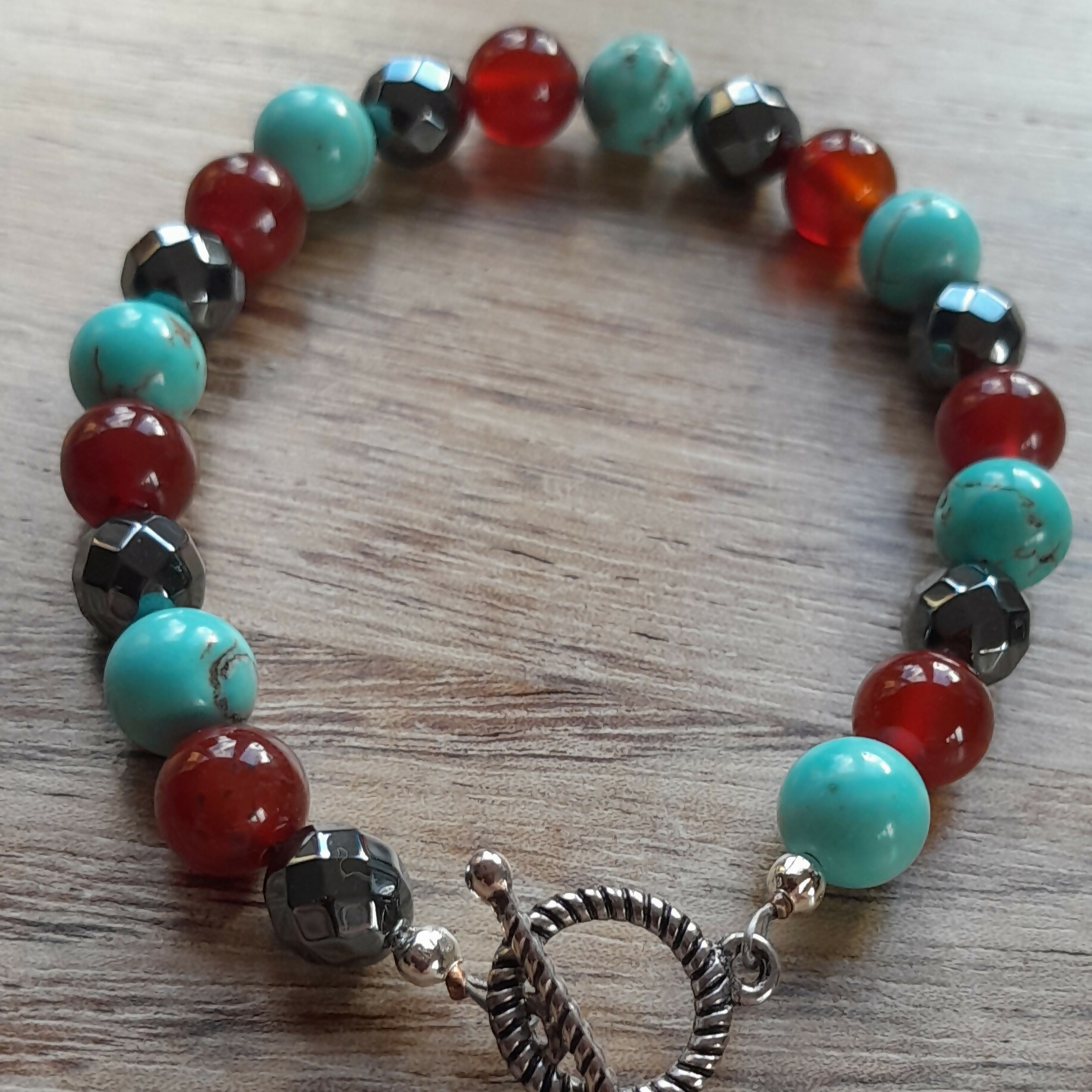 Tibetan Silver Toggle Catch Bracelet with Faceted Grey Hematite, Carnelian and Turquoise.