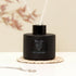 Reed Diffuser with black glass bottle and white reeds